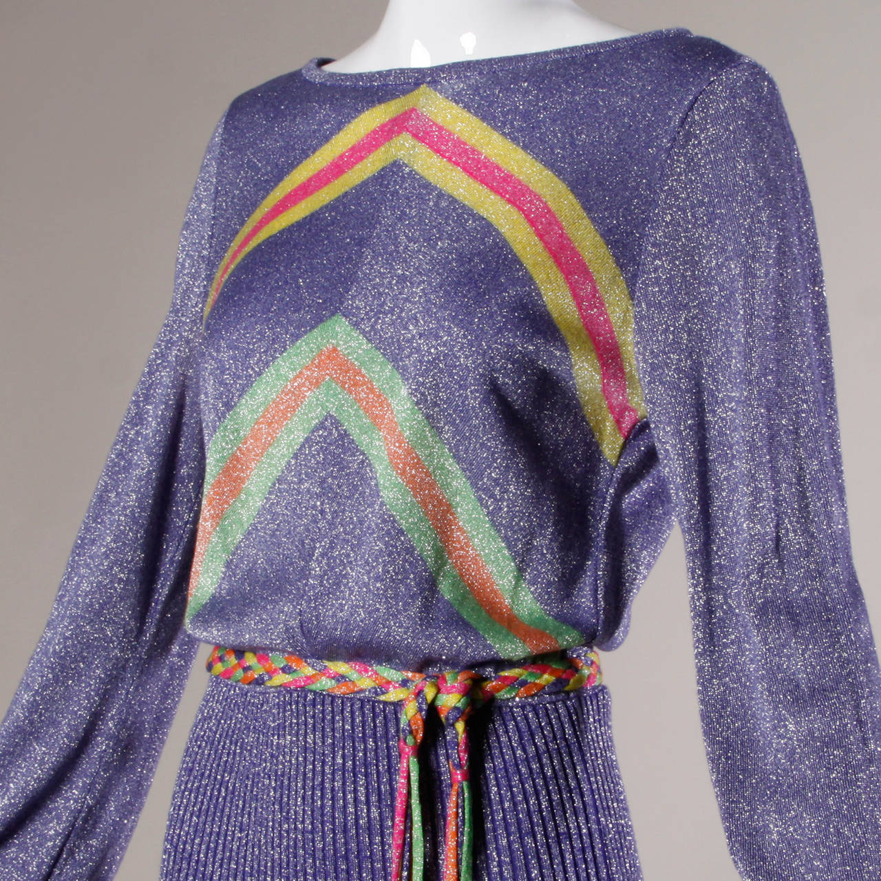 Banff Ltd. by Gianni Ferri purple metallic knit maxi dress with colorful stripes and a matching sash.

Details:

Unlined
Matching Belt
Back Zip Closure
Marked Size: Not Marked
Estimated Size: S-M
Color: Purple/ Silver Metallic/ Mustard/
