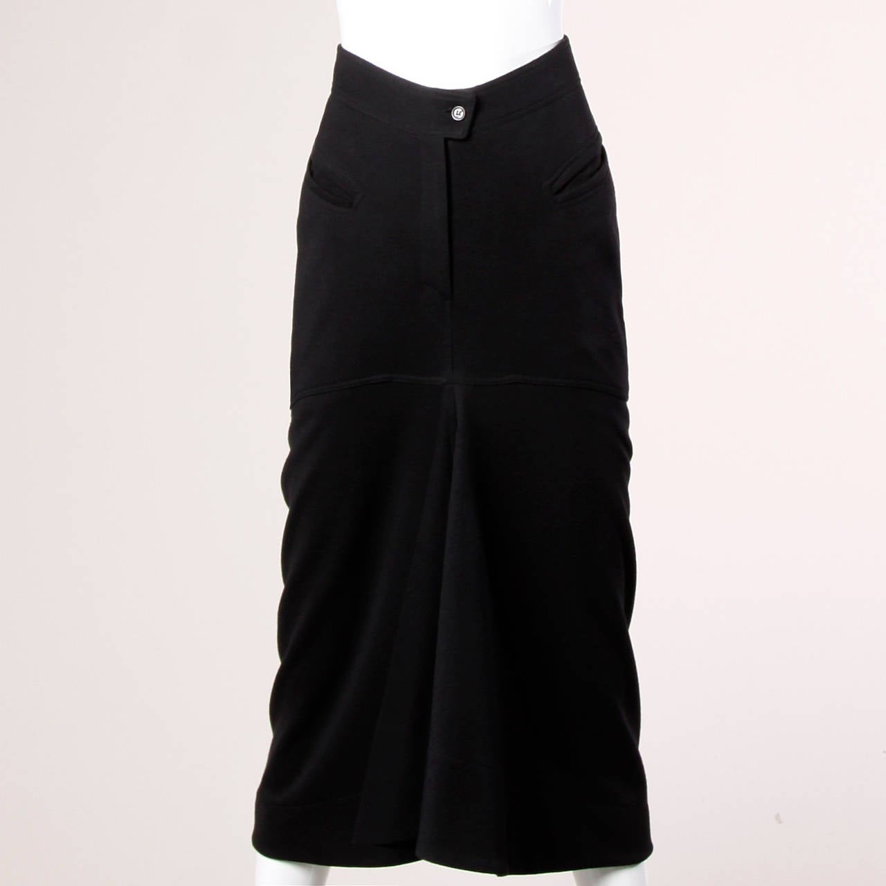 Unique vintage black wool skirt by Claude Montana with a flounce hem and body hugging fit. Zipper detailing adds a sporty look to the piece.

Details:

Partially Lined
Front Button and Zip Closure
Marked Size: US 8/ I 42/ F 40/ GB 34/ D
