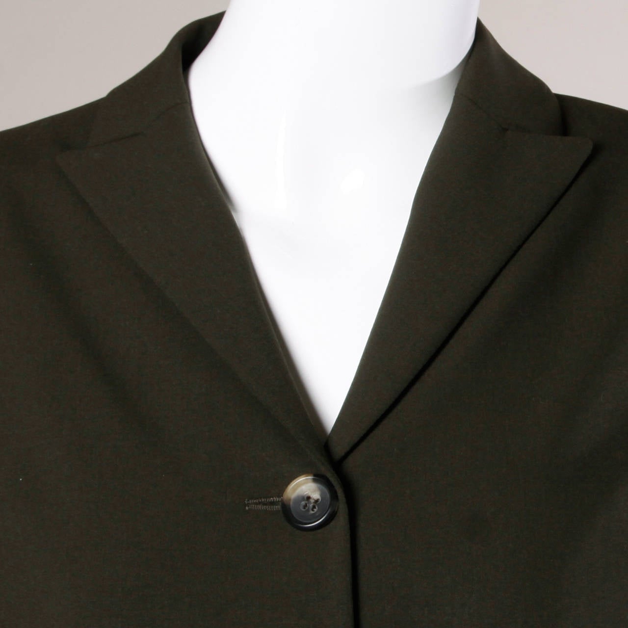 Minimalist dark green wool blazer jacket by Jil Sander.

Details:

Fully Lined
Front Pockets
Shoulder Pads Are Sewn Into Lining
Front Button Closure
Marked Size: 34
Color: Dark Green
Fabric: 96% Wool and 4% Elastic/ 55% Viscose and 45%