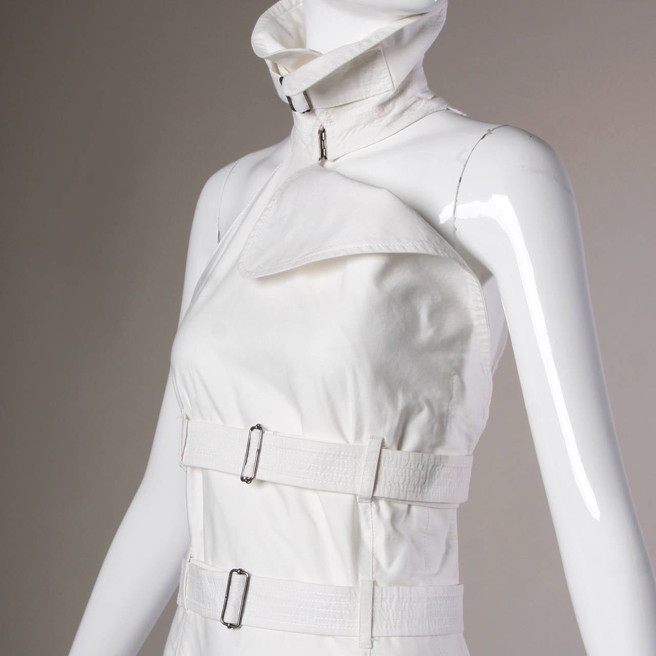 Reduced from $1,295! Iconic vintage straitjacket-inspired bondage dress by Jean Paul Gaultier featuring a high collar with buckle, sleeveless sleeves and a triple belted midsection. All three of the belts are fully adjustable and removable so it