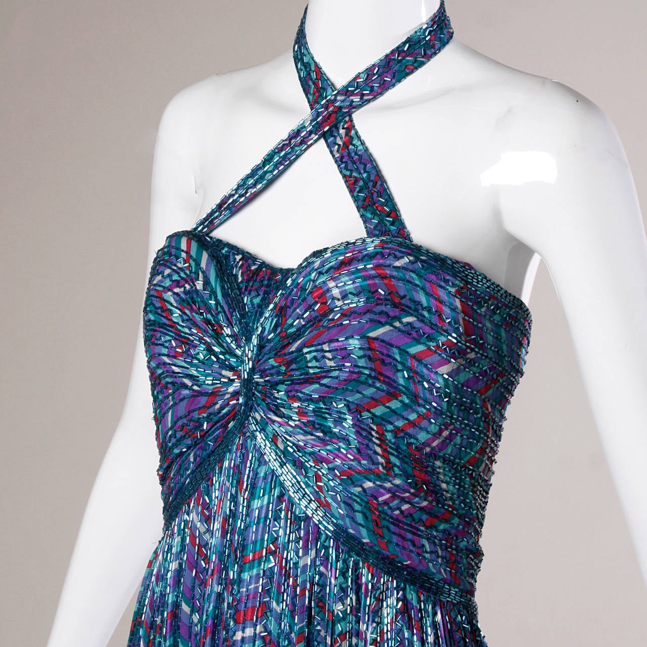 Details:

Fully Lined
Back Zip and Hook Closure
Marked Size: 8
Estimated Size: XS-S
Color: Iridescent Turquoise/ Sea Blue/ Green Turquoise/ White/ Purple
Fabric: 100% Silk
Label: Bob Mackie/ Isaacson's Atlanta

Measurements:

Bust: