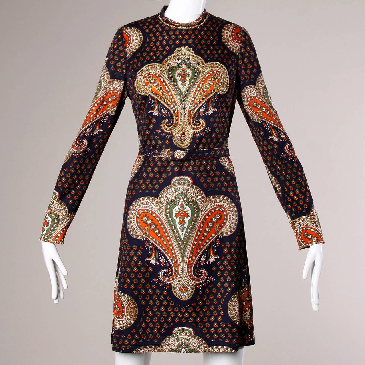 Beaded Gino Charles mini dress with an elaborate paisley print and matching belt.

Details:

Unlined
Matching Belt
Back Zip Closure
Marked Size: Not Marked
Estimated Size: Small-Medium
Color: Navy/ Orange/ Green/ White/ Multicolored