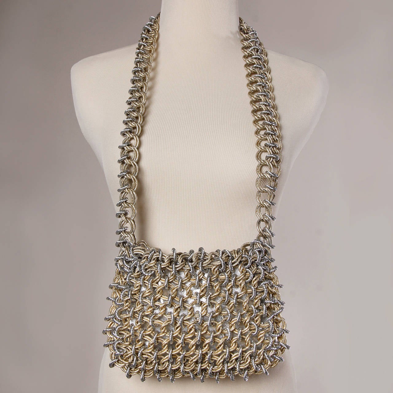 Phenomenal heavy chain maille vintage shoulder bag with long shoulder strap and metallic vinyl lining. Huge gold and silver tone metal links. An amazing piece!

Details:

Fully Lined
Top Latch Closure
One Size
Color: Silver Metallic/ Gold