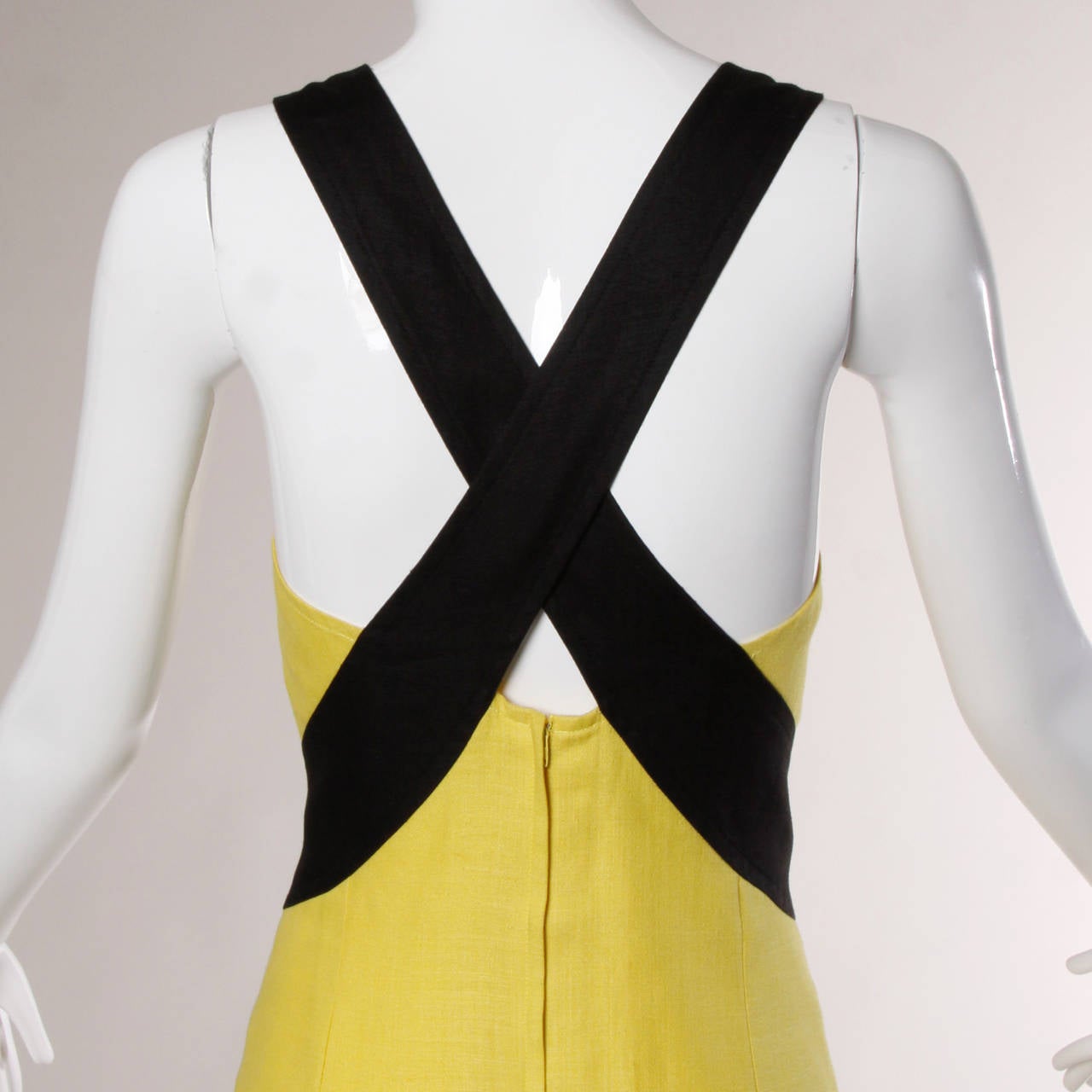 Yellow and black sheath dress with an open criss cross back by Guy Laroche.

Details

Fully Lined
Side Pockets
Back Zip Closure
Circa: 1980s
Estimated Size: M
Colors: Black / Yellow
Fabric: Linen
Label: Guy Laroche