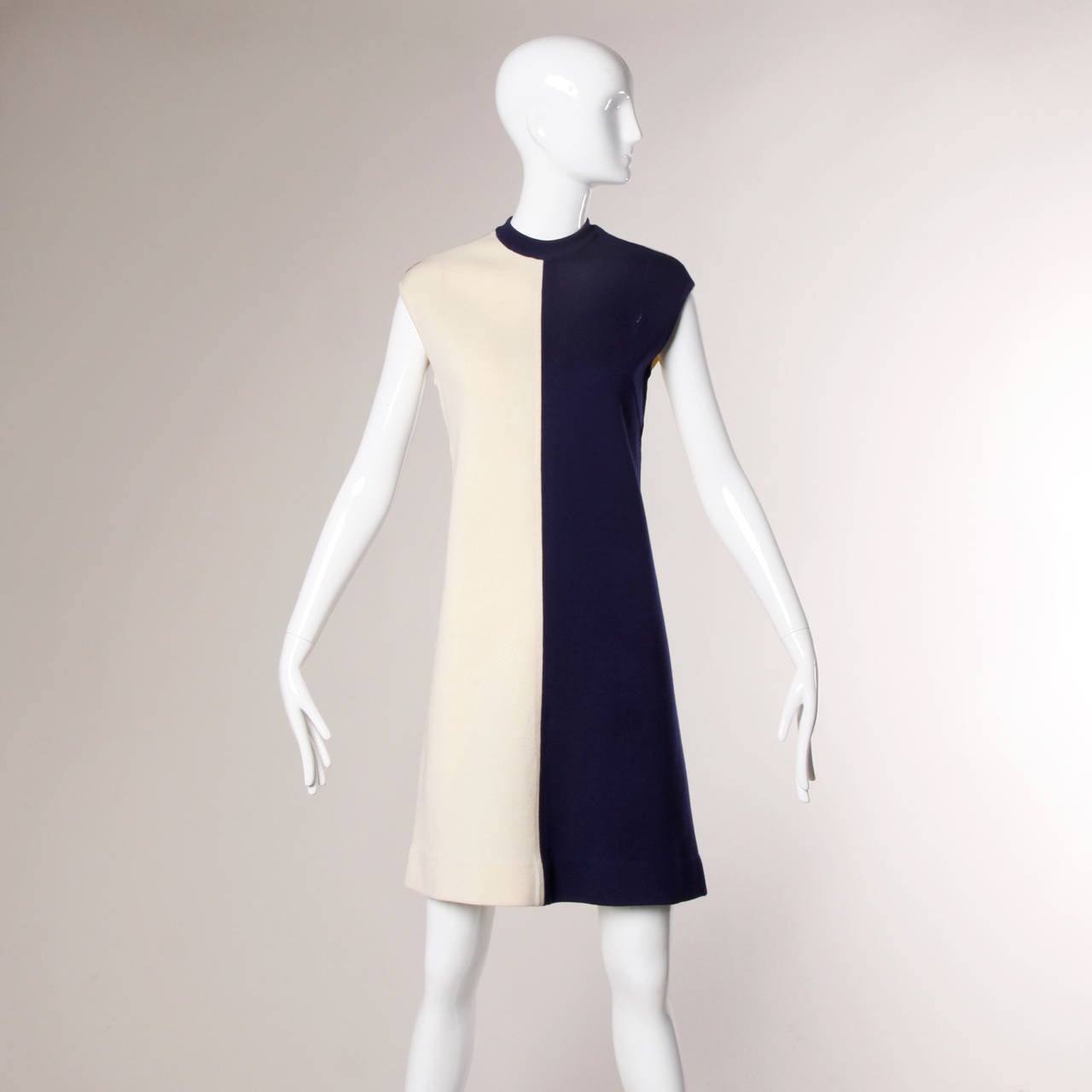 1960s vintage navy and off-white wool knit 2-piece ensemble that can be worn together or as separates. Geometric mod striped design with a military vibe. Two-tone shift dress with sleeveless sleeves and a high neck.

Details:

Unlined
Back Zip
