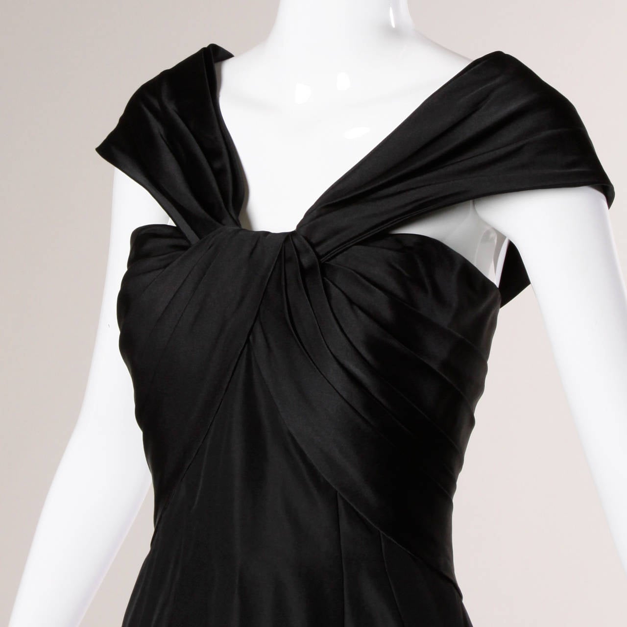 Beautifully constructed vintage 50s or 60s cocktail dress with couture detailing and waist stay. Very well made!

Details:

Fully Lined
Back Metal Zip and Hook Closure
Marked Size: Not Marked
Estimated Size: Small
Color: Black
Label: Not