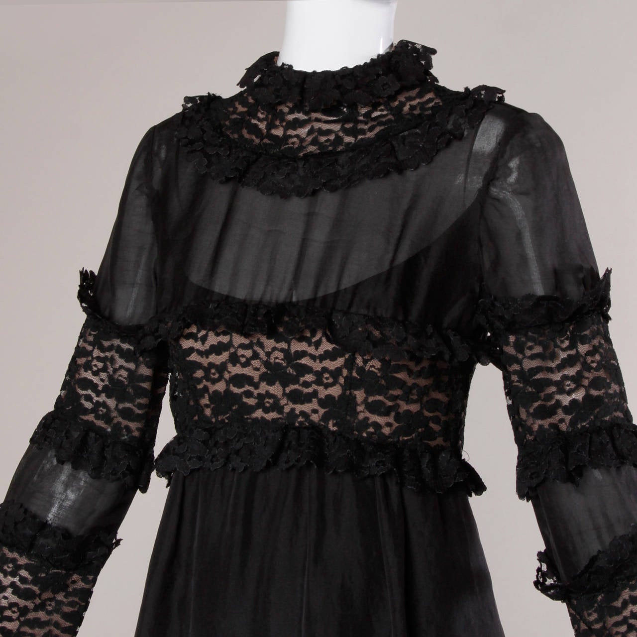 Incredible 1960s Victorian-inspired black lace dress by Ferdinando Sarmi. Nude illusion and sheer silk panels and lace ruffle trim. Couture construction with hand stitched details throughout the dress.

Details:

Partially Lined
Back Button