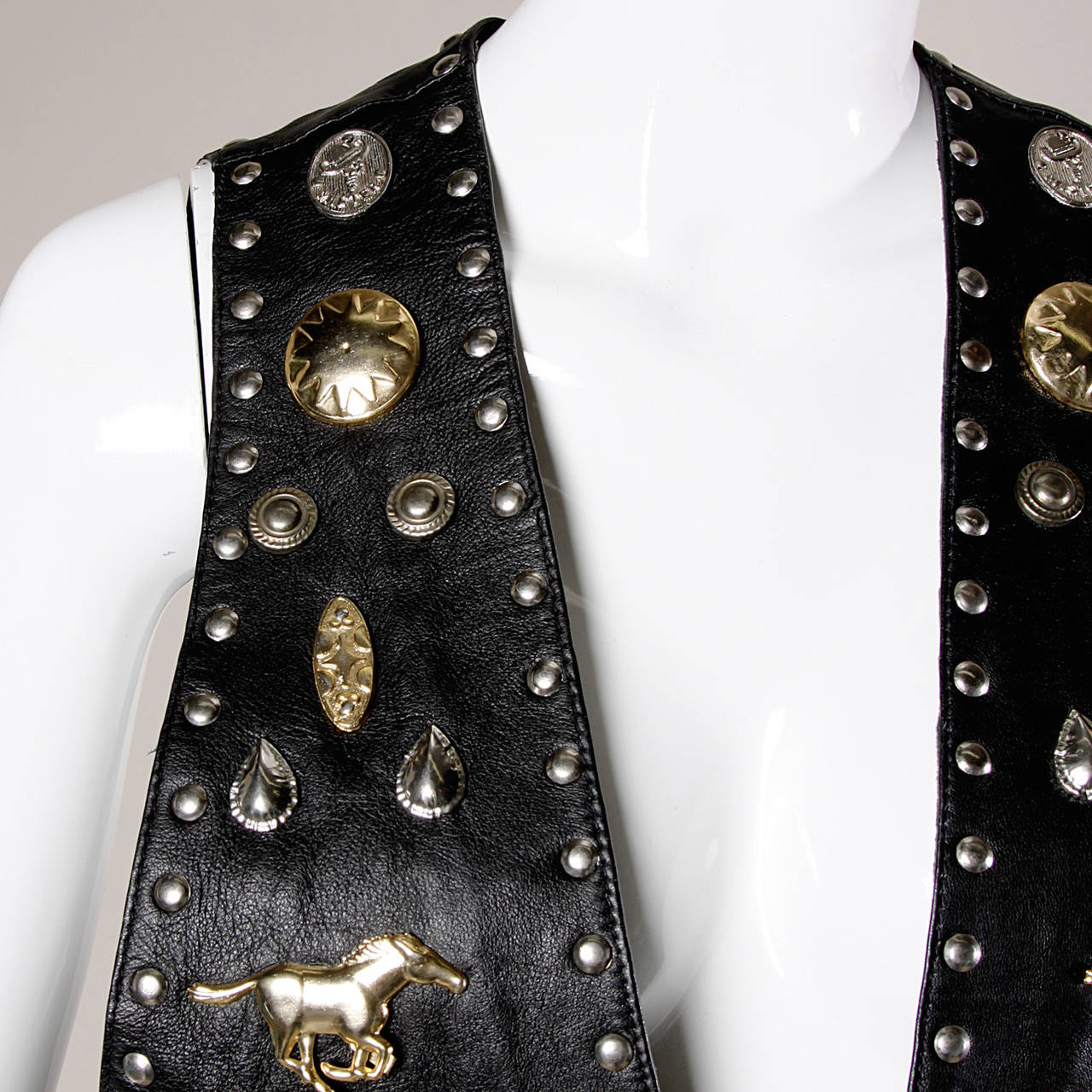 Unique vintage leather vest with oversized novelty studwork featuring horses, cowboy boots and conchos. Heavy and hand made!

Details:

Fully Lined
No Closure
Marked Size: Not Marked
Estimated Size: Free
Color: Black/ Silver and Gold