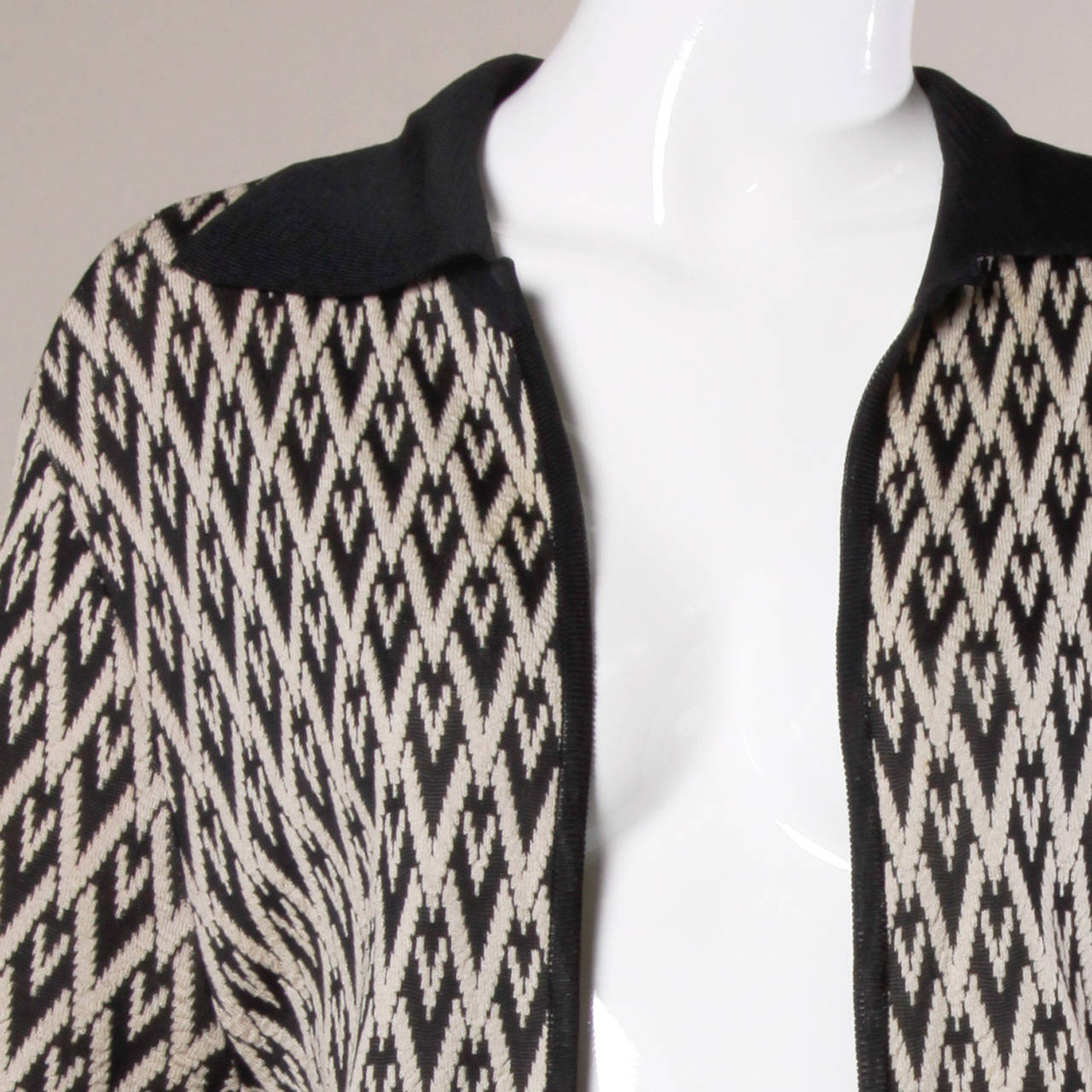 Fantastic oversized knit cardigan coat in a geometric black and tan design. Contrasting black knit collar, long sleeves and open front. Oversized fit will fit a S-L. 

Details:

Unlined
No Closure
Estimated Size: S-L
Color: Black/
