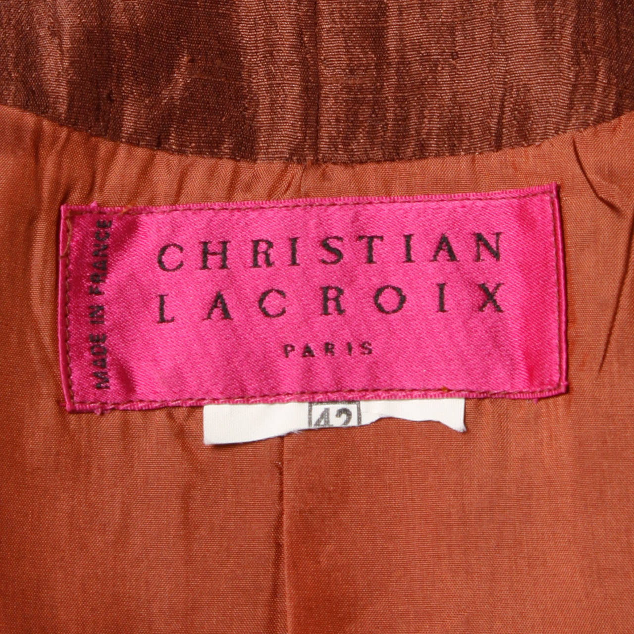 Chocolate brown silk steam punk tuxedo jacket by Christian Lacroix. Unique buttons and flattering cut.

Details:

Fully Lined
Front Button Closure
Marked Size: 42
Estimated Size: M
Colors: Brown/ Bronze
Fabric: Silk
Label: Christian