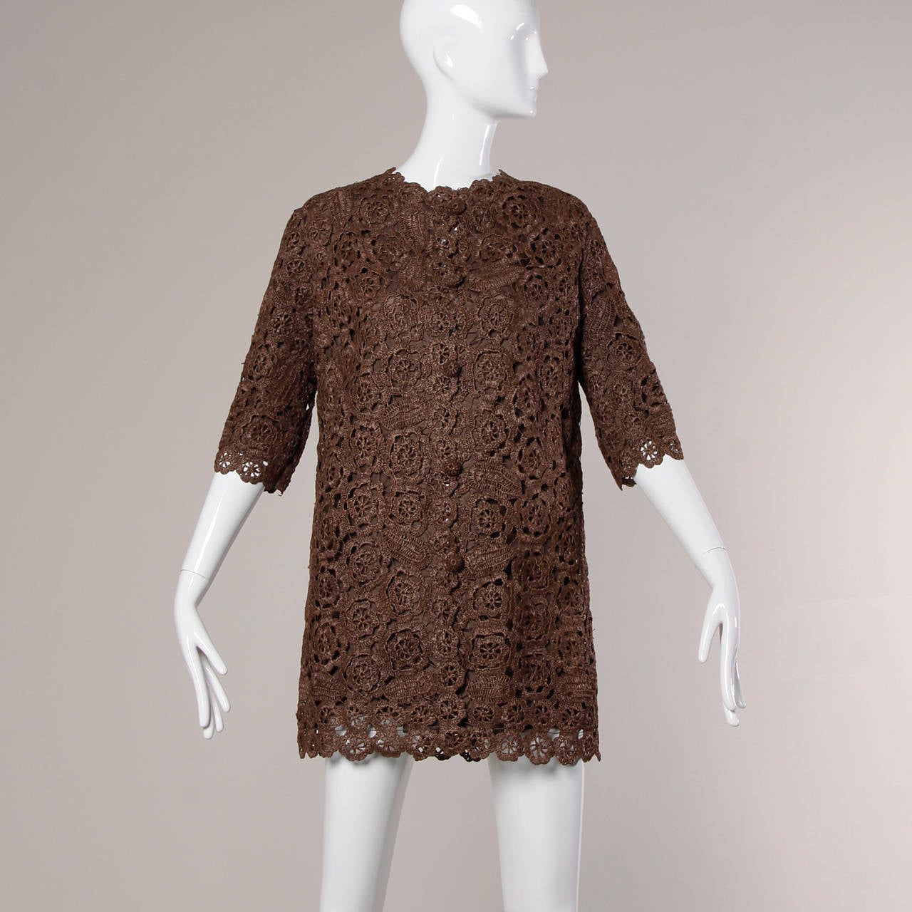 Hand crocheted brown raffia coat or jacket with a scalloped design and matching buttons.

Details:

Fully Lined
Front Button Closure
Marked Size: Not Marked
Estimated Size: Free
Color: Brown
Fabric: Hand Crochet Raffia
Label: Not