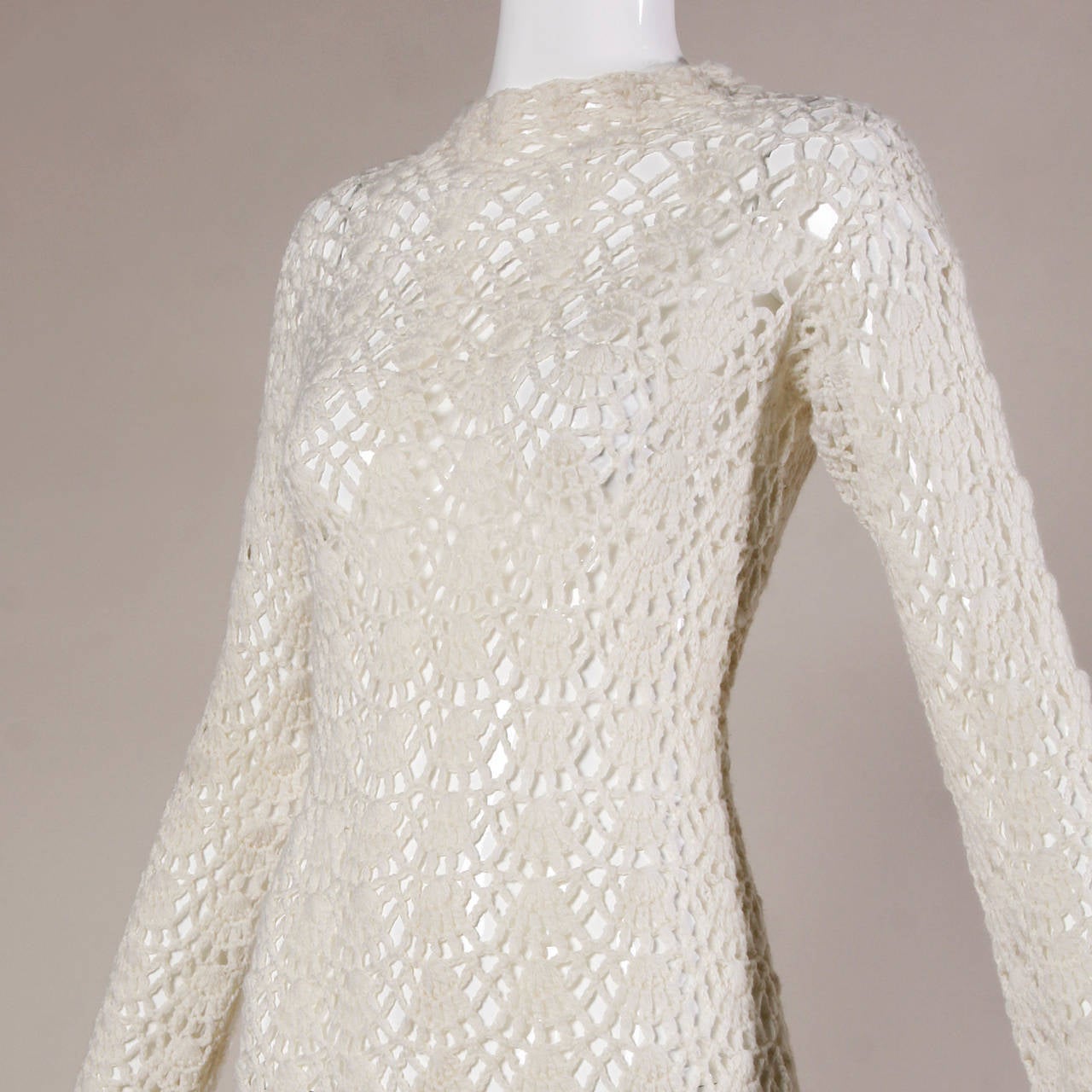 Hand crocheted mini dress with long sleeves and a scalloped design. Completely sheer.

Details:

Unlined
Back Button Closure
Marked Size: Not Marked
Estimated Size: Small-Medium
Color: Ivory
Fabric: Not Marked/ Feels Like
