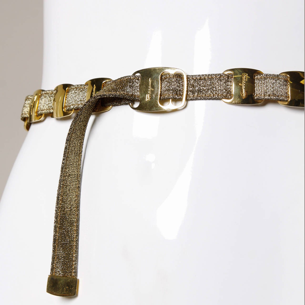 Vintage Salvatore Ferragamo metallic gold belt with heavy gold tone links that are signed Ferragamo. Fully adjustable.

Details:

Unlined
Adjustable Front Buckle Closure
Marked Size: Not Marked (Adjustable)
Color: Gold Metallic
Materials: