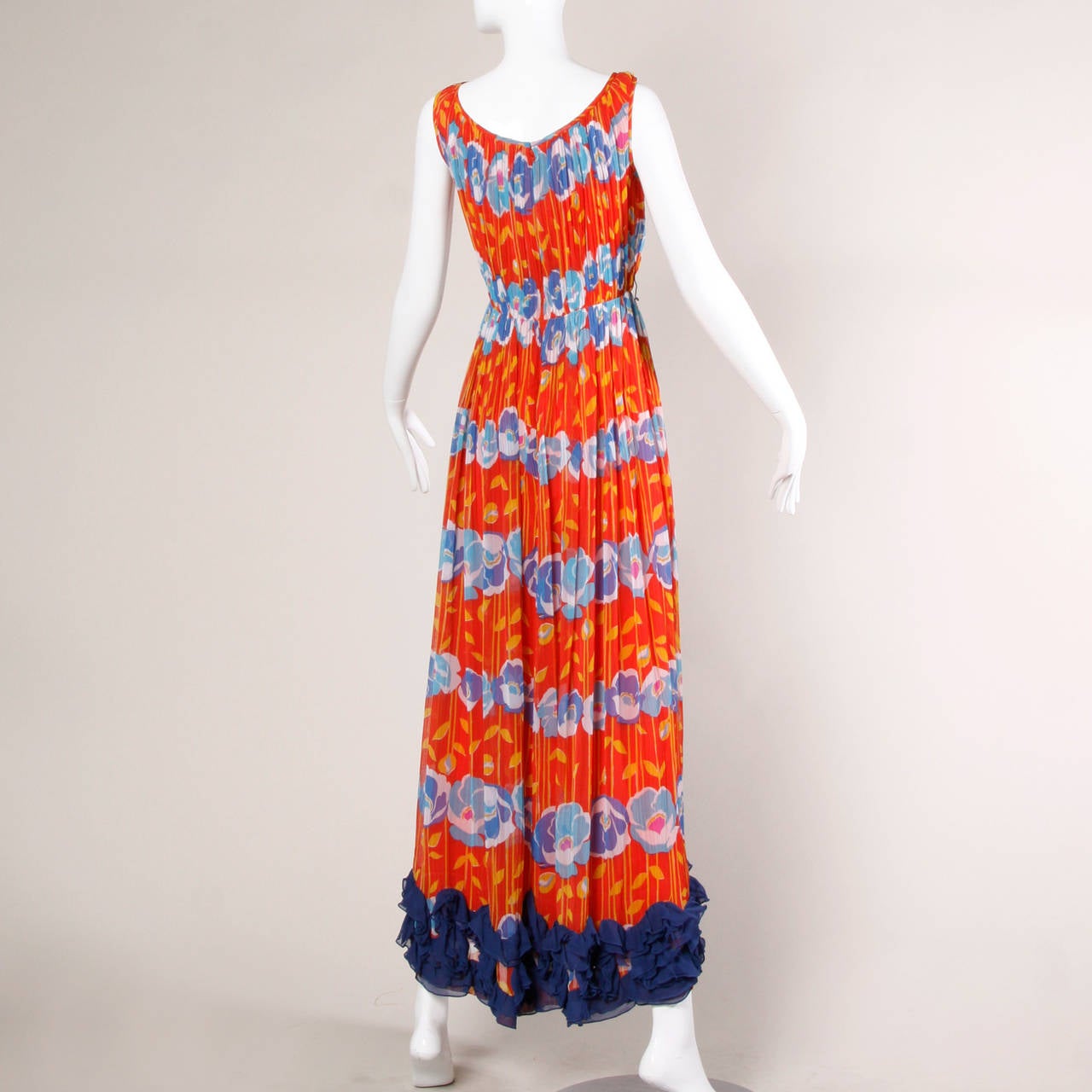 Red floral print maxi dress by Victor Costa for Romantica. Blue ruffle detail along the bottom hem of the dress.

Details:

Fully Lined
Back Zip and Hook Closure
Marked Size: 10
Estimated Size: Medium
Color: Bright Red, Yellow, Blue and