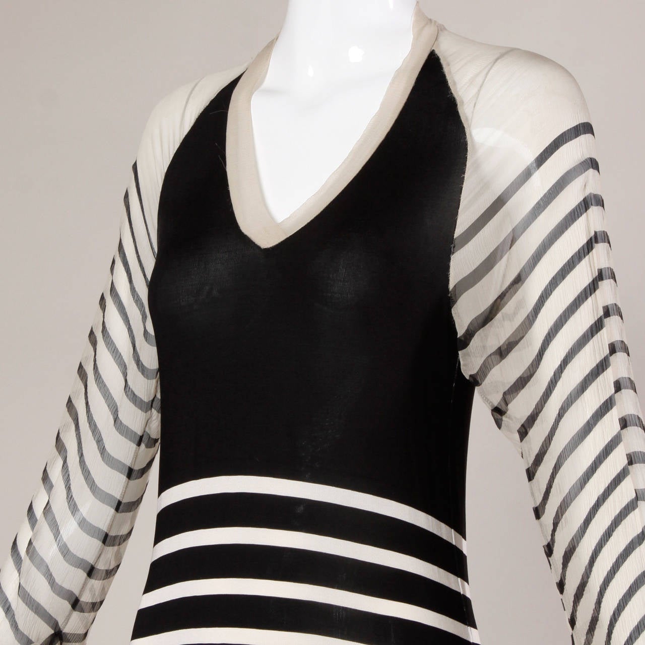 Delicate jersey knit dress with sheer silk chiffon sleeves by Jean Paul Gaultier. Black and off-white stripes.

Details:

Unlined
No Closure/ Fabric Contains Stretch
Marked Size: S
Color: Off White/ Black
Fabric: 100% Silk On Top/ 96% Rayon