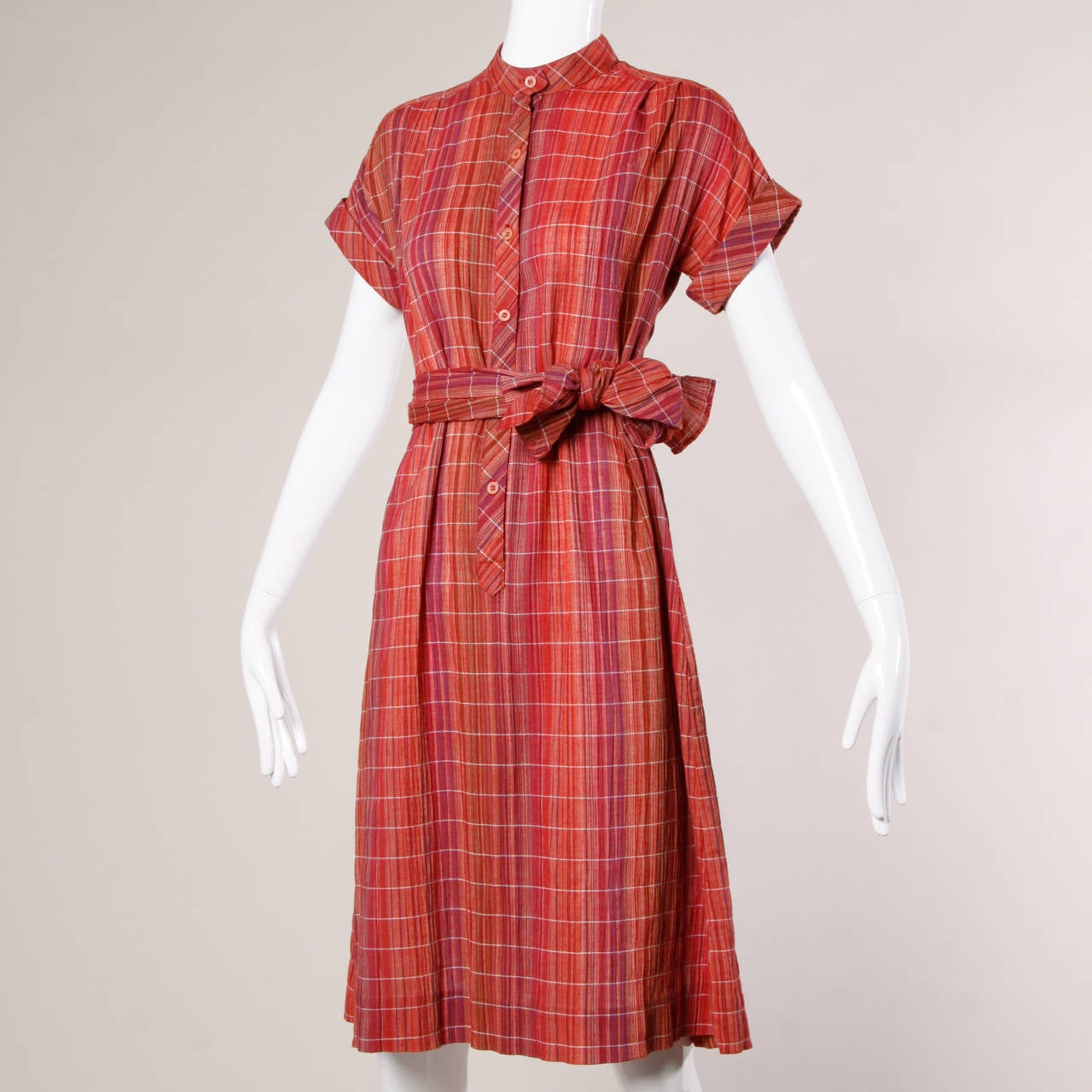 Vintage Pierre Balmain plaid dress and sash ensemble that can be worn different ways. Rare label from the 70s!

Details:

Unlined
Matching Sash
Front Button Closure
Marked Size: 10
Estimated Size: Medium
Color: Magenta/ Blood Red/