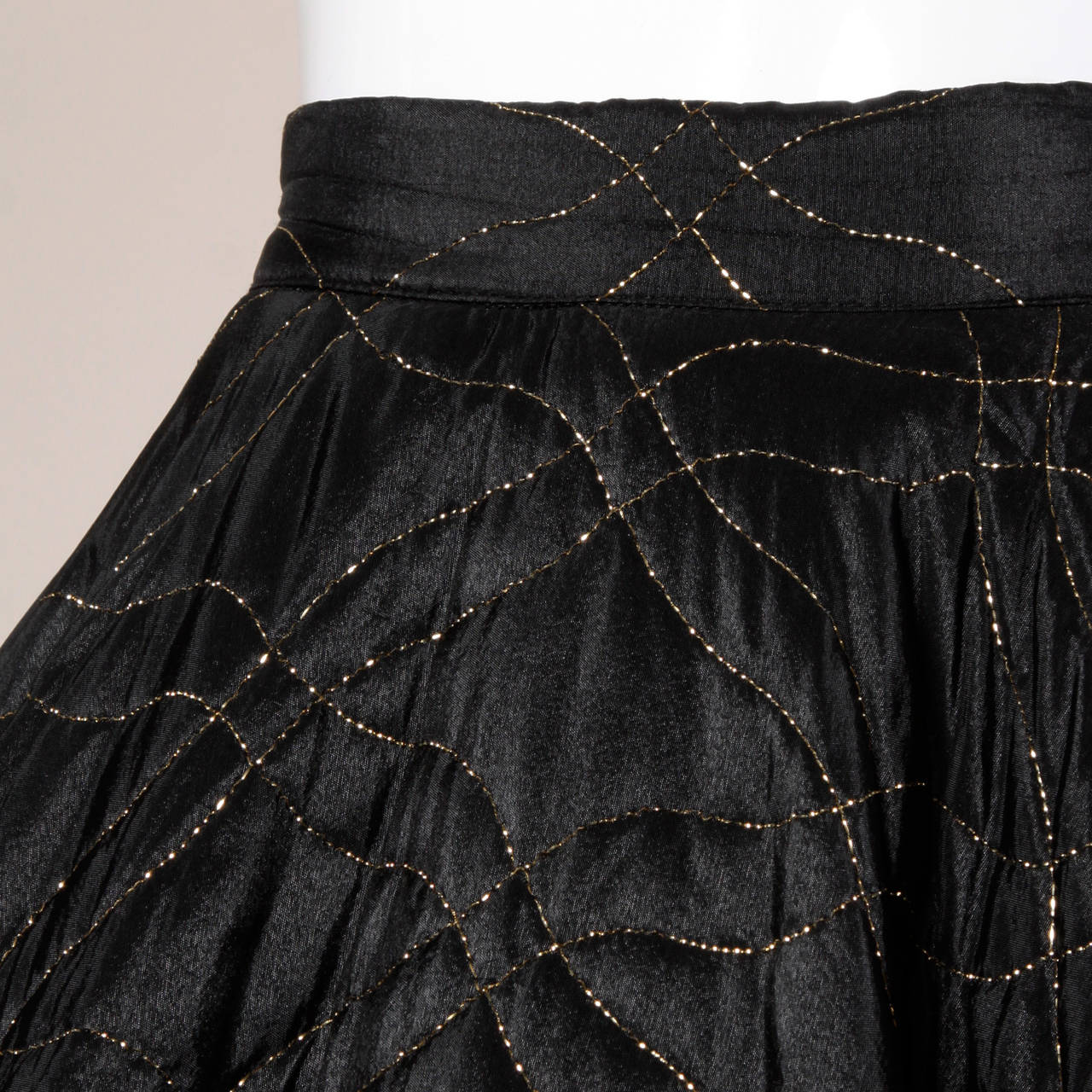 Full circle skirt from the 1950s with a 360 degree sweep, heavy weight fabric and metallic gold quilting. Photographed with a crinoline for extra volume which is not included.

Details:

Unlined
Side Metal Zip and Button Closure
Marked Size: