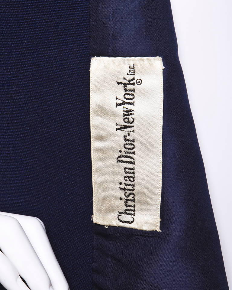 Absolutely stunning navy blue wool vintage coat by Christian Dior in phenomenal pristine condition (looks unworn!). Immaculate tailoring and construction with military-inspired detailing and notched lapels. The coat closes in front with a row of