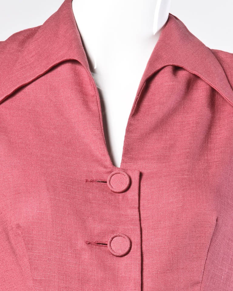 Lovely vintage dusty rose linen skirt suit with a matching short sleeve jacket and skirt. Both pieces are unlined and embellished with covered buttons.

Details:

Unlined
Front Button and Snap Closure On Top/ Side Metal Zip and Button Closure