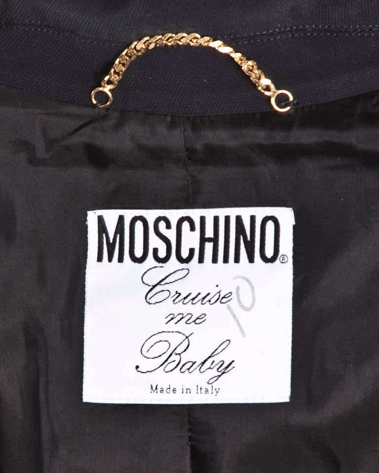 Vintage black Matador-inspired jacket with tassels on the edge of each sleeve and embroidered hearts and scrolls. Notched lapels and front button closure. Fully lined. Rare Moschino 