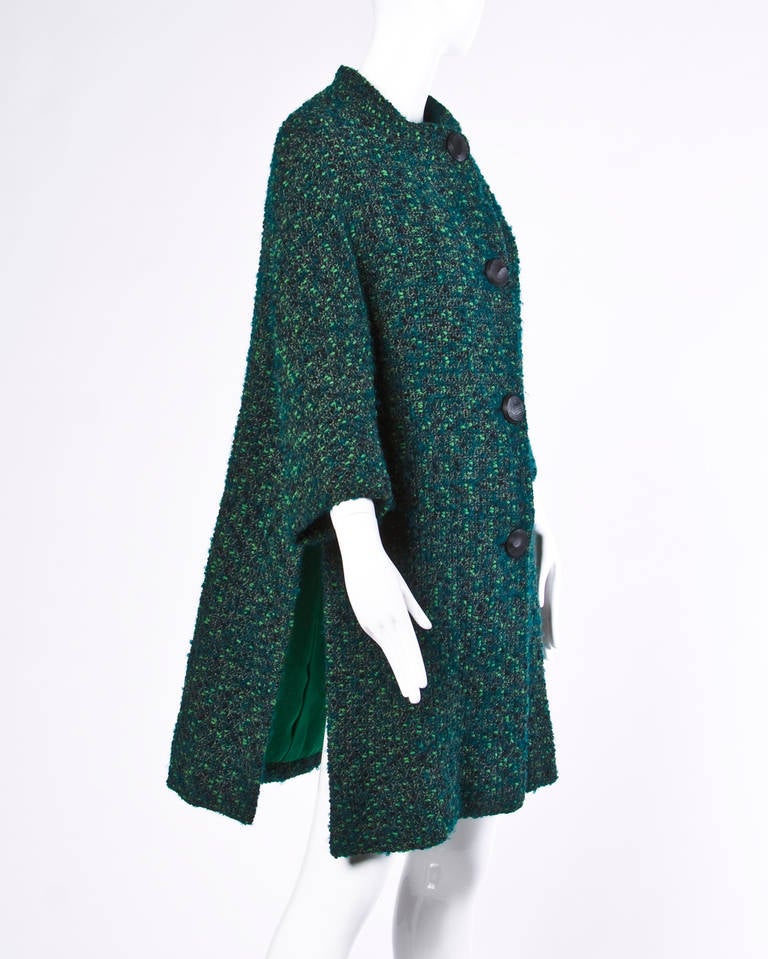 Reduced from $795. Chic 1960s green boucle wool swing coat by Nina Ricci. Carved black buttons and kelly green lining. High slits on both sides.

Details:

Fully Lined
Front Button Closure
Circa: 1960's
Marked Size: Not Marked
Color:
