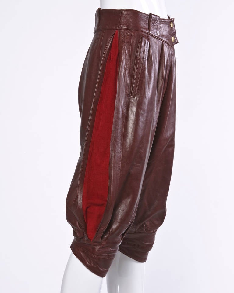 Stunning soft buttery oxblood lambskin leather cropped pants by Claude Montana pour Ideal Cuir. Unique suede paneled sides and extraordinary craftsmanship and quality. Fully lined with front snap and zip closure.

Marked Size: FR 38
Estimated