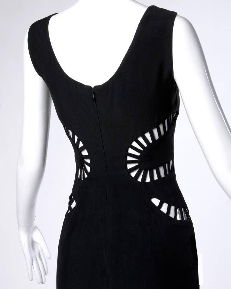 Completely unique Sophie Sitbon black dress with a cut out snake detail with wraps around the midriff. The snake head starts on your right with the tail ending on the left! 

Details:

Partially Lined
Back Zip Closure
Marked Size: