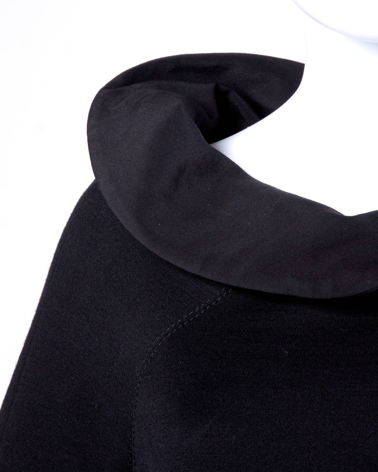 Black wool and silk avant garde tunic dress by Gianfranco Ferre. Unique avant garde shape with an asymmetric neckline and 