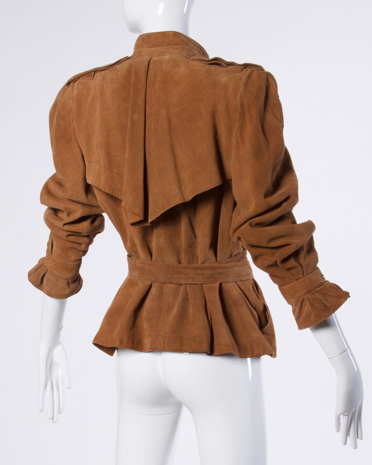 Vintage 1980s brown suede leather jacket by Claude Montana pour Ideal Cuir. Silver avant garde hardware and bold shoulders. Iconic Claude Montana silhouette.

Details:

Fully Lined
Front Pockets/ Chest Pocket
Attached Matching Belt
Front Snap