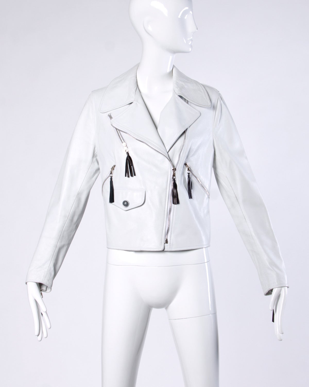 Gorgeous white leather motorcycle jacket with black leather tassels and faded black writing across the back in Italian 