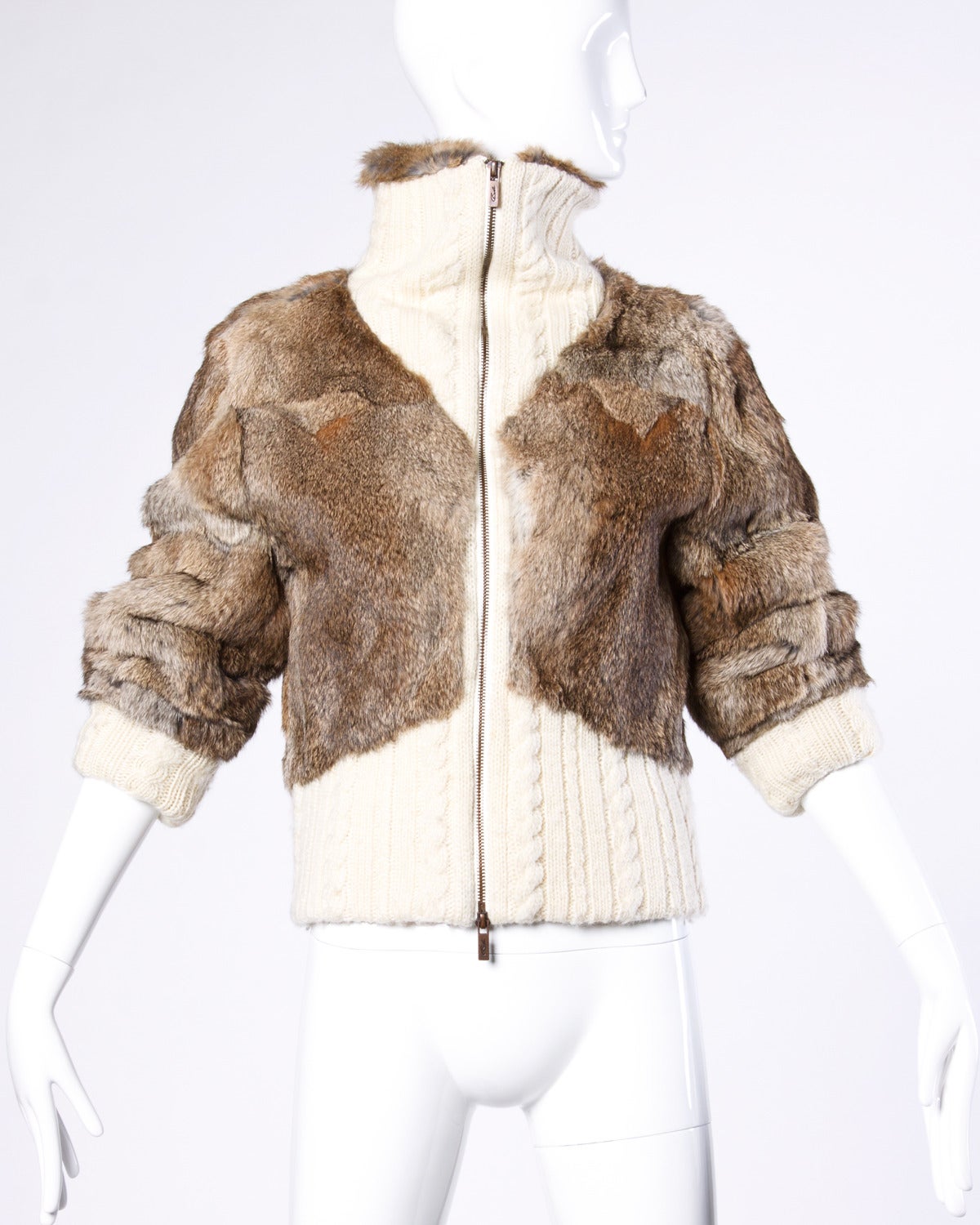 Fantastic brown rabbit fur bomber jacket with ivory knit cuffs and trip. Zip up turtleneck collar.

Details:

Fully Lined
Front Metal Zip
Marked Size: Large
Estimated Size: Small-Medium
Color: Ivory/ Brown/ Black
Fabric: Wool Blend/ Rabbit