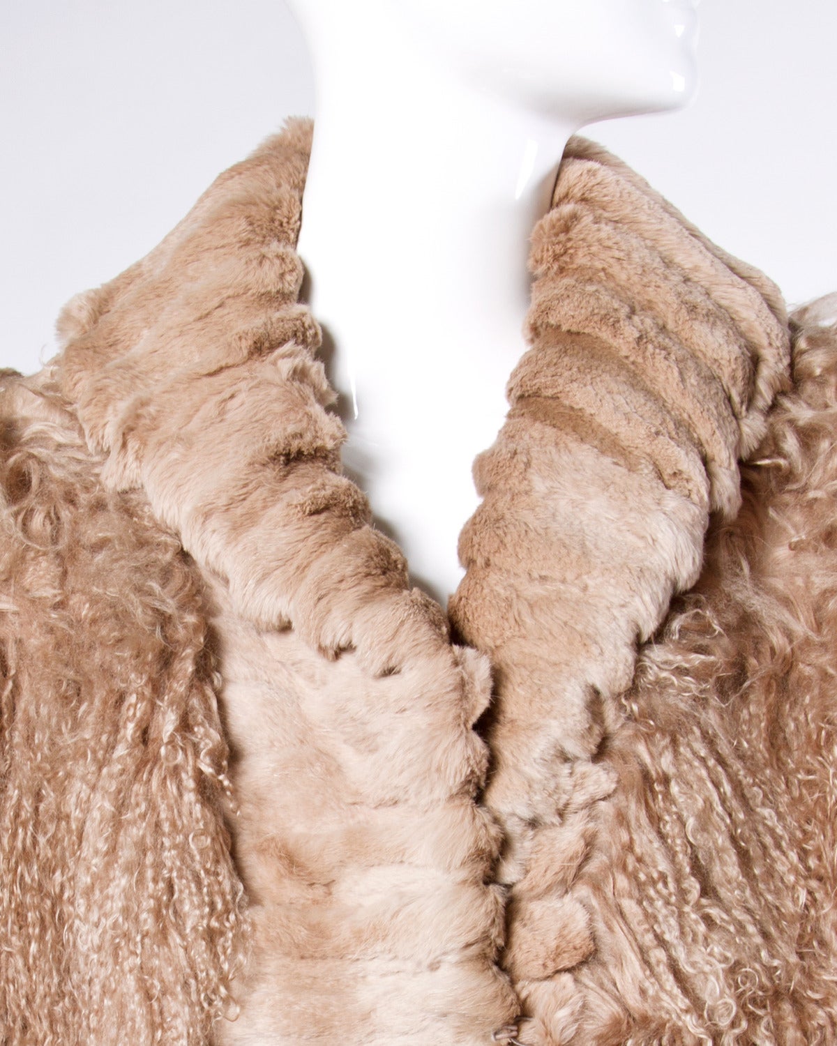 Dyed light brown Tibetan lamb fur coat with sheared rabbit fur trim.

Details:

Fully Lined
Front Pockets
Shoulder Pads Sewn Into Lining
Front Hook Closure
Marked Size: XL
Estimated Size: M-XL
Fabric: Genuine Dyed Tibet Lamb/ Sheared
