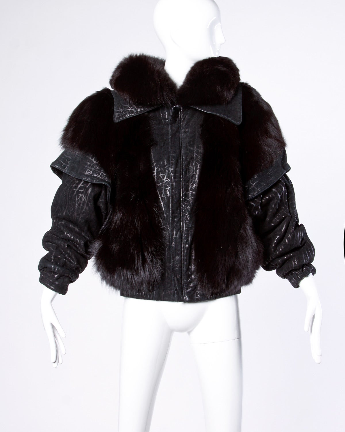Avant garde black fox fur and textured leather jacket. High quality glossy fox fur is in excellent condition. Oversized bomber-style fit.

Details:

Fully Lined
Side Pockets
Shoulder Pads Sewn Into Lining
Front Zip Closure
Estimated Size: