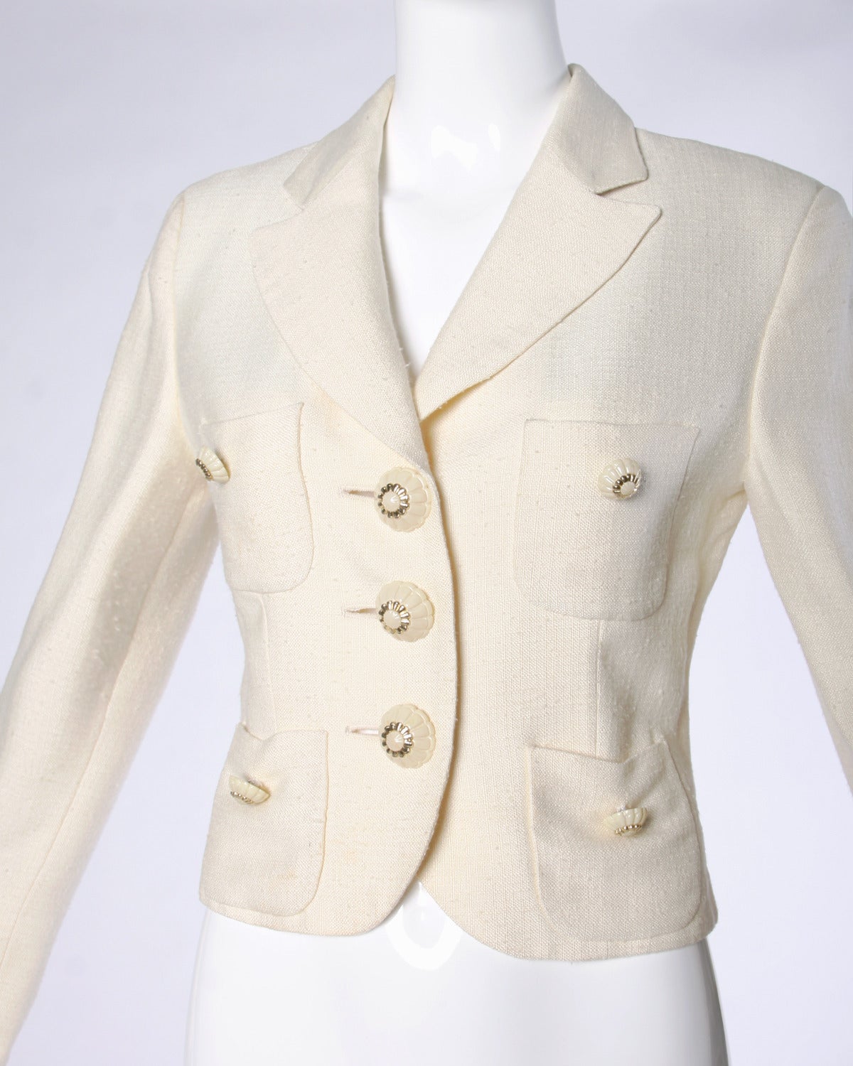 Gorgeous cream jacket with unique buttons and front pockets. By Moschino Couture!

Details: 

Fully Lined
Front Pockets
Shoulder Pads Sewn Into Lining
Front Button Closure/ Button Closure At Wrist
Marked Size: I 42/ D 38/ F 38/ GB 10/ US