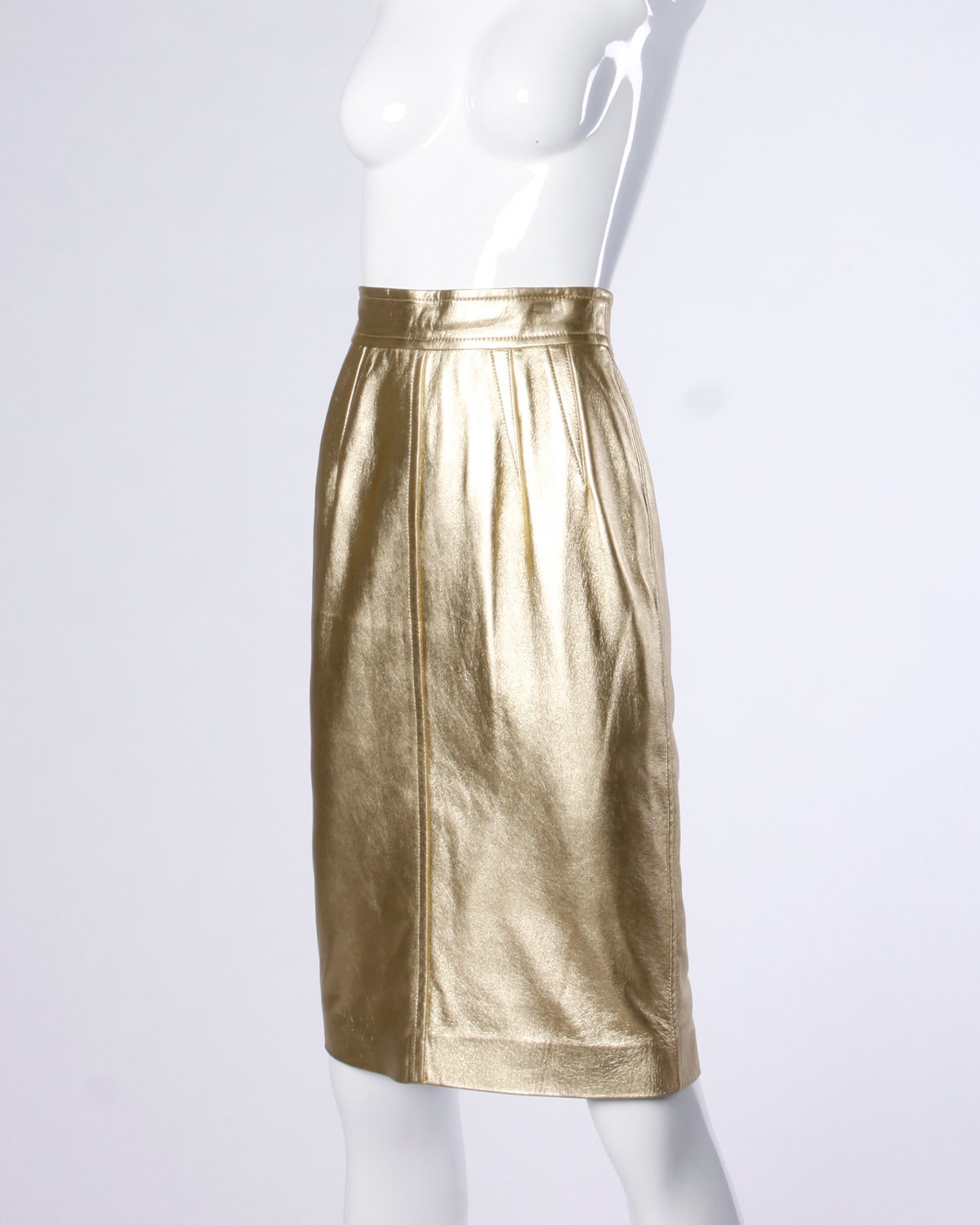 Gorgeous vintage metallic gold leather pencil skirt by Escada!

Details:

Fully Lined
Back Zip and Snap Closure
Marked Size: 34
Color: Gold Metallic
Fabric: Leather/ Rayon
Label: ESCADA

Measurements:

Waist: 26