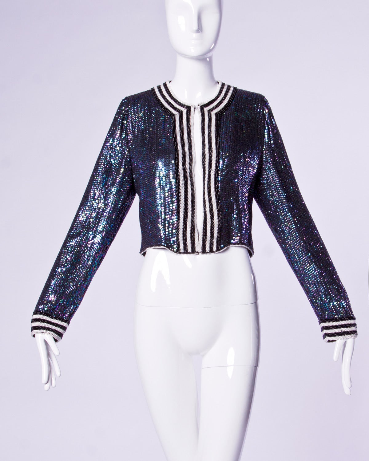 Rare Estevez couture silk jacket with iridescent blue sequins and beaded trim. This jacket features two white birds on the back which are made up entirely of sequins and beads.

Details: 

Fully Lined
Front Hook Closure
Marked Size: