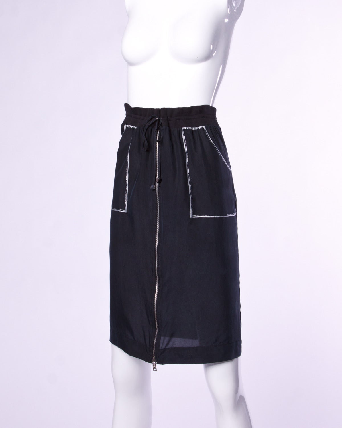 Fantastic JC de Castelbajac black silk skirt with trompe l'oeil faux cartoon stitching and pockets. 

Details:

Unlined
Front Metal Zip Closure/ Drawstring at Waist
Marked Size: 42
Color: Black/ Silver
Fabric: Silk
Label: JC de Castelbajac