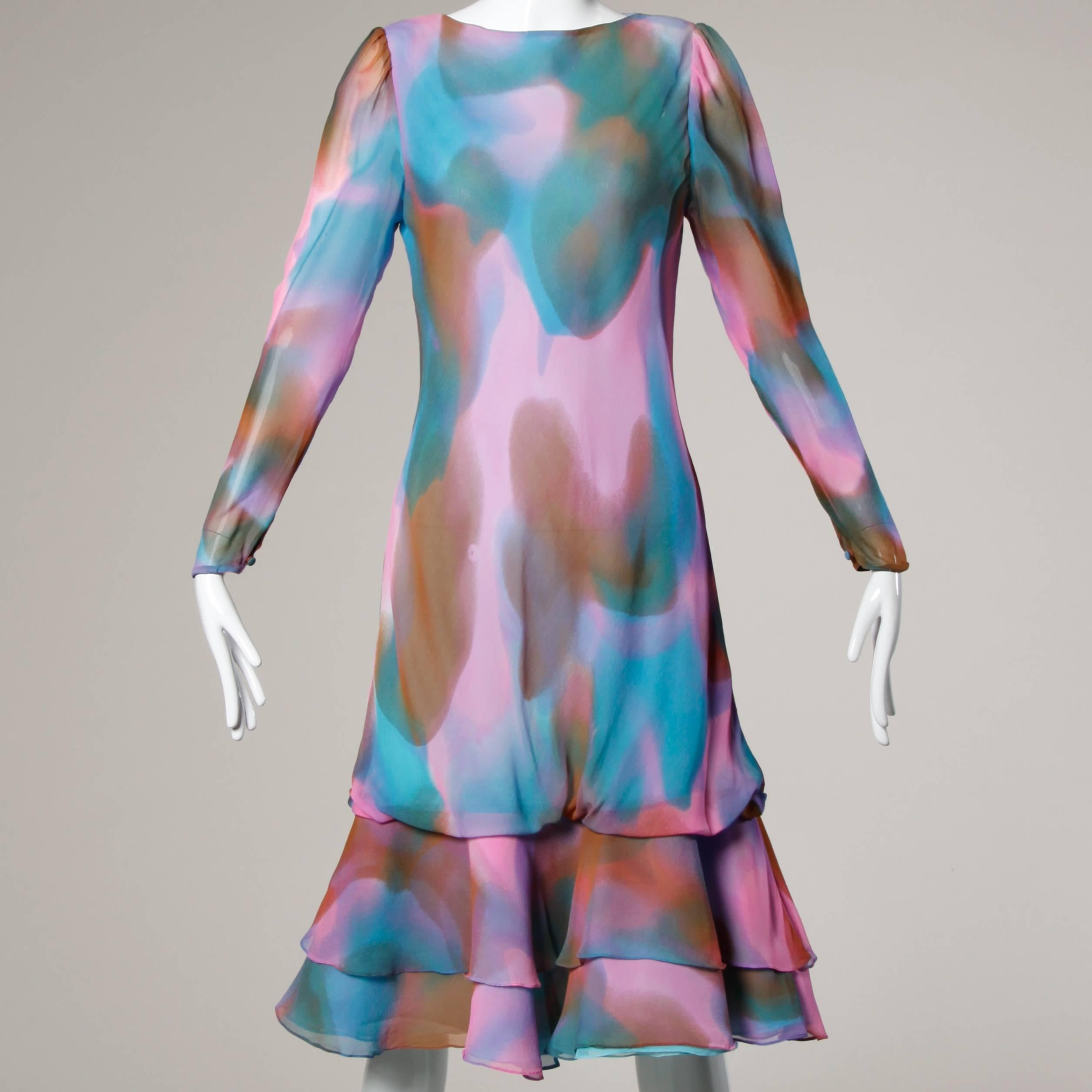 Beautiful hand painted silk dress and matching wrap ensemble by Judy Hornby for Neiman Marcus in watercolor shades of pink, brown, teal and purple.

Details:

Fully Lined
Matching Wrap
Marked Size: US 10
Estimated Size: Medium
Color: Pink/