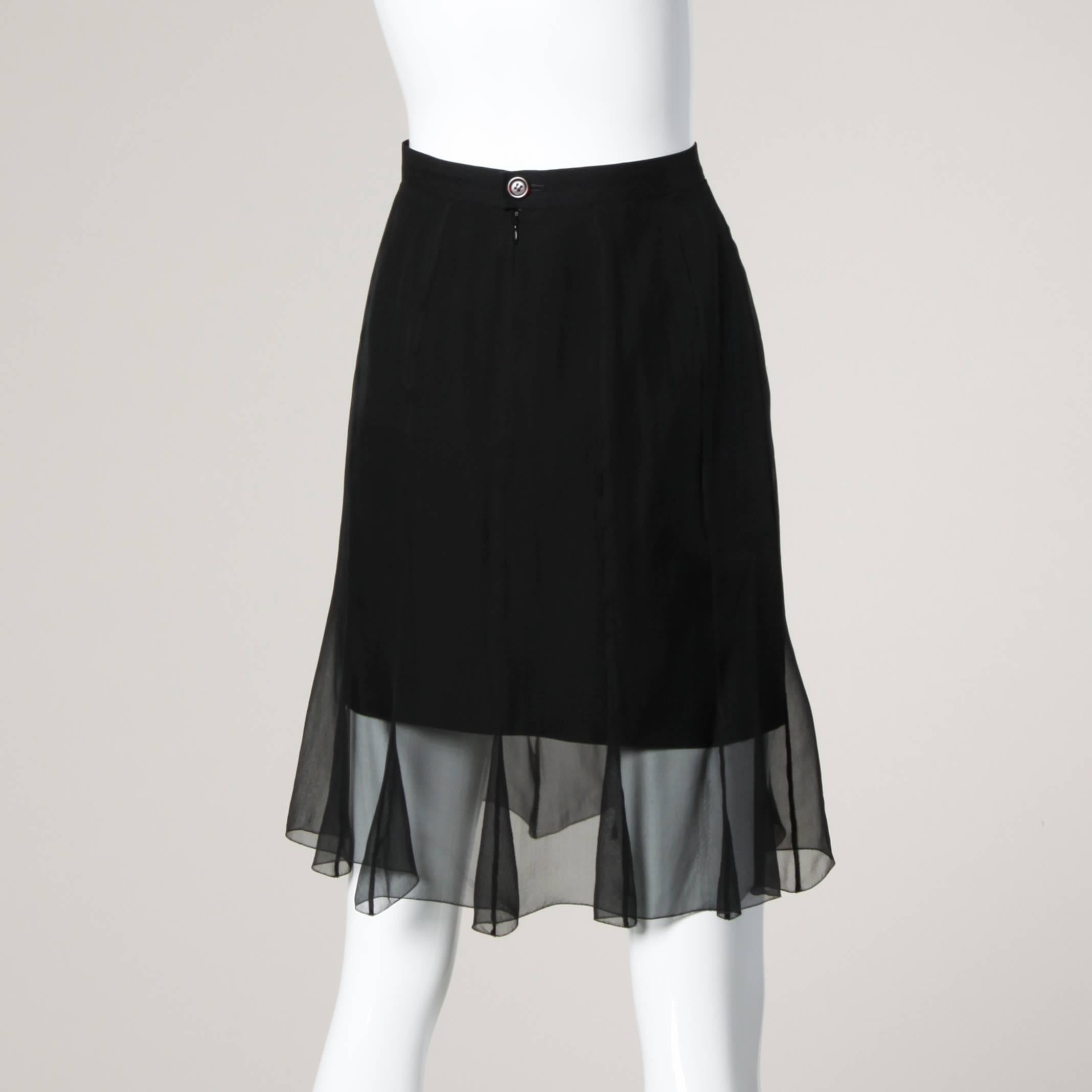 Karl Lagerfeld black skirt with a sheer mesh overlay. Simple and chic.

Details:

Fully Lined
Back Zip and Button Closure
Marked Size: 40
Estimated Size: Medium
Color: Black
Fabric: 32% Viscose/ Acetate 61%/ 7% Polyamide
Label: Karl