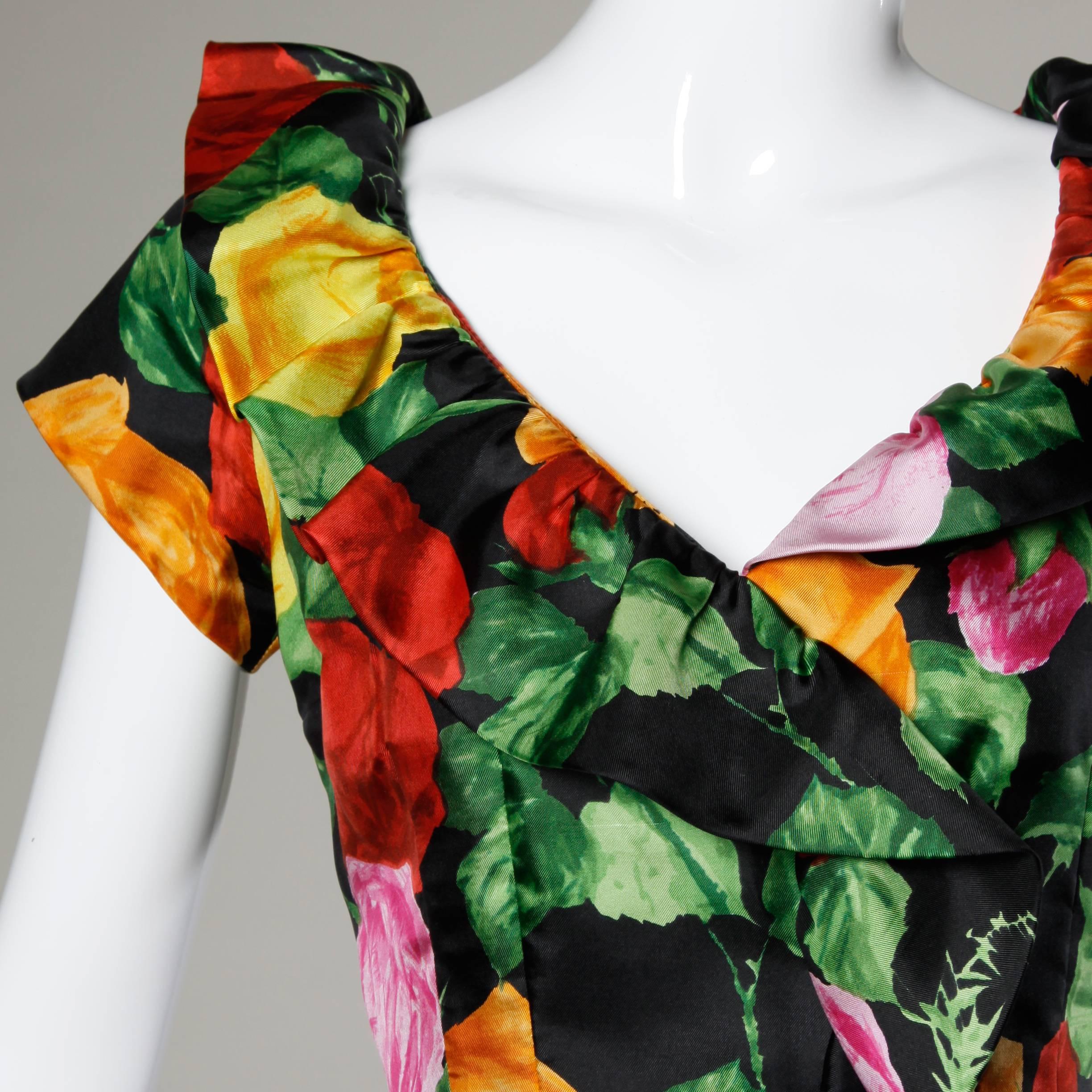 Gorgeous silk fabric! Vintage 1960s cocktail dress with a vibrant floral print and front ruffle detail.

Details:

Fully Lined
Back Zip and Hook Closure
Estimated Size: Small
Color: Black/ Green/ Red/ Orange 
Fabric: Silk
Label: