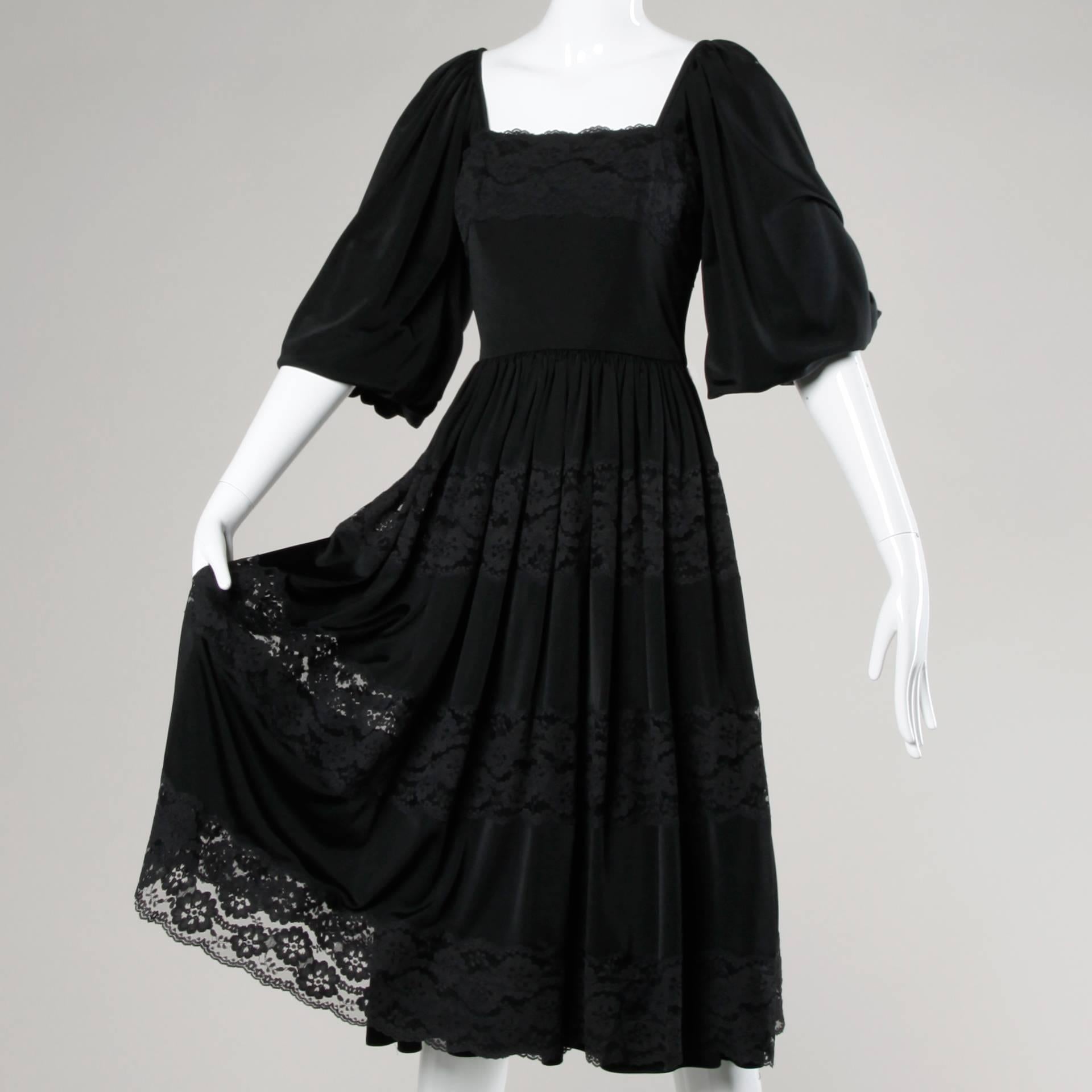 Vintage 1970s black bohemian-inspired dress by Donald Brooks. Lace trim and full balloon sleeves.

Details:

Fully Lined
Back Zip and Hook Closure 
Marked Size: US 6
Estimated Size: Small
Color: Black
Fabric: Jersey Knit/ Lace
Label: