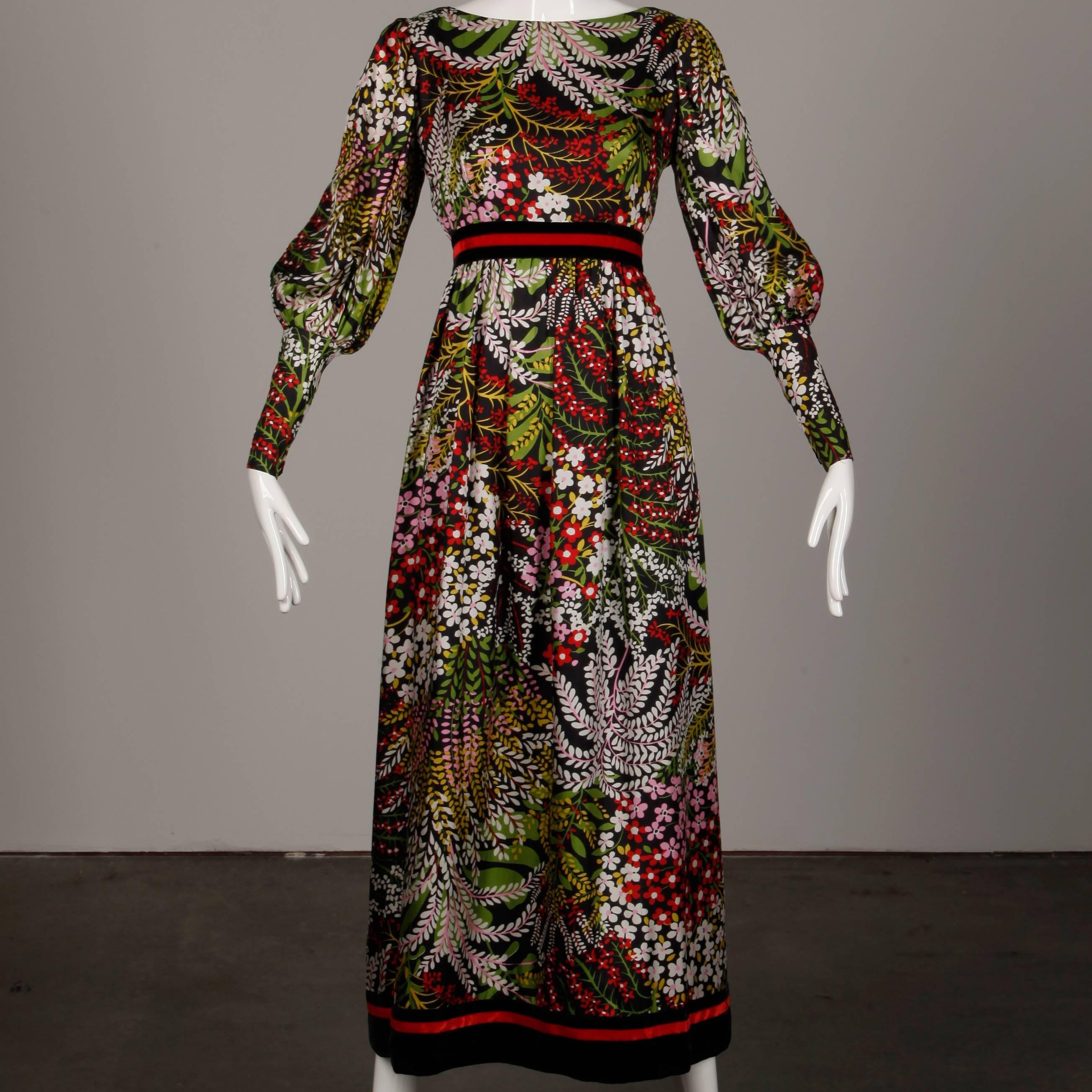 Gorgeous floral printed maxi dress by Mollie Parnis. Full balloon sleeves and velvet empire waistband and bottom hem. 

Fully lined with rear zip and hook closure and snap closure at wrists. 100% silk. The bust measures 34