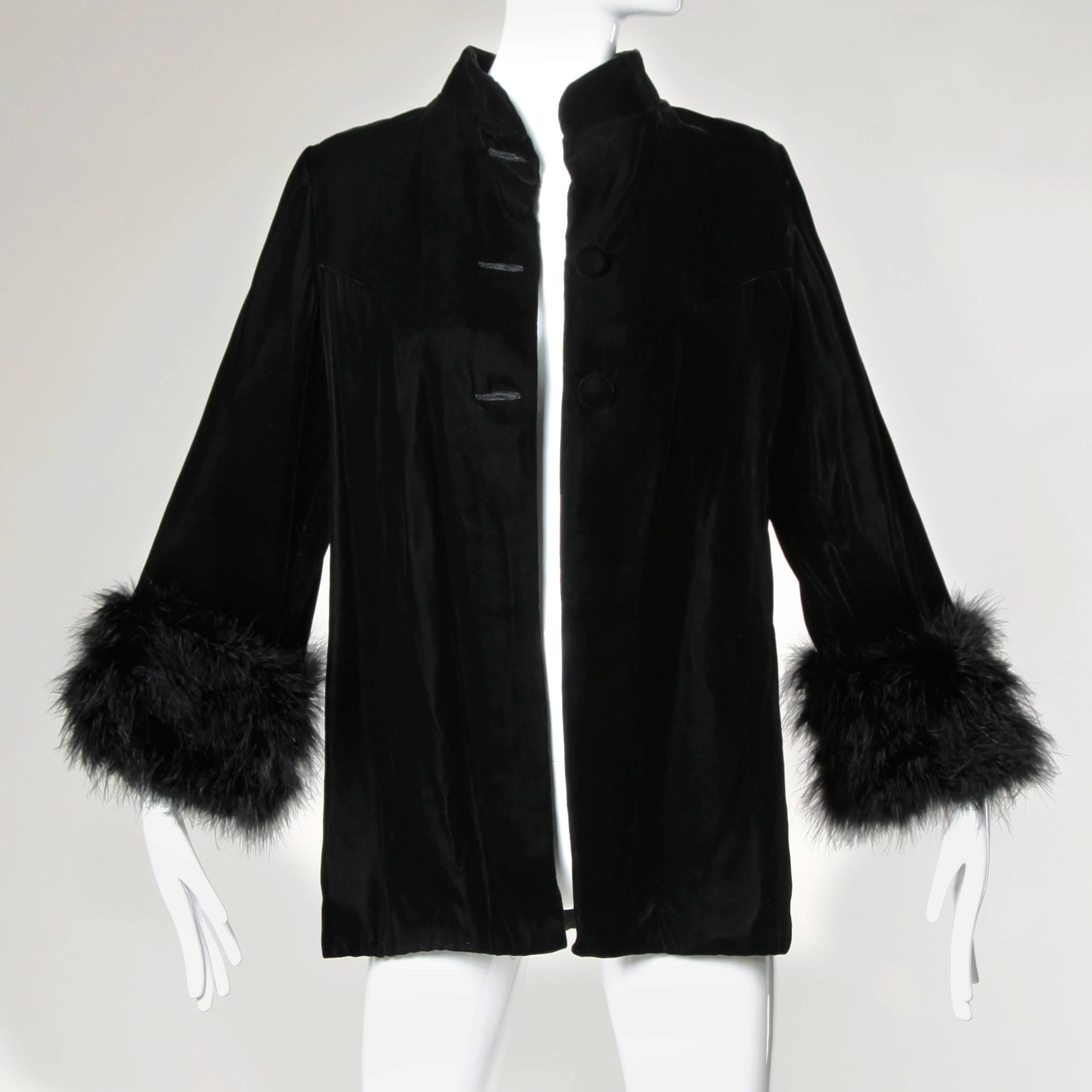 Elegant vintage black velvet jacket with soft marabou feather cuffs. Large covered buttons and swing shape.

Details:

Fully Lined
Front Button Closure 
Marked Size: Medium
Estimated Size: Medium
Color: Black
Fabric: Velvet/ Marabou
Label: