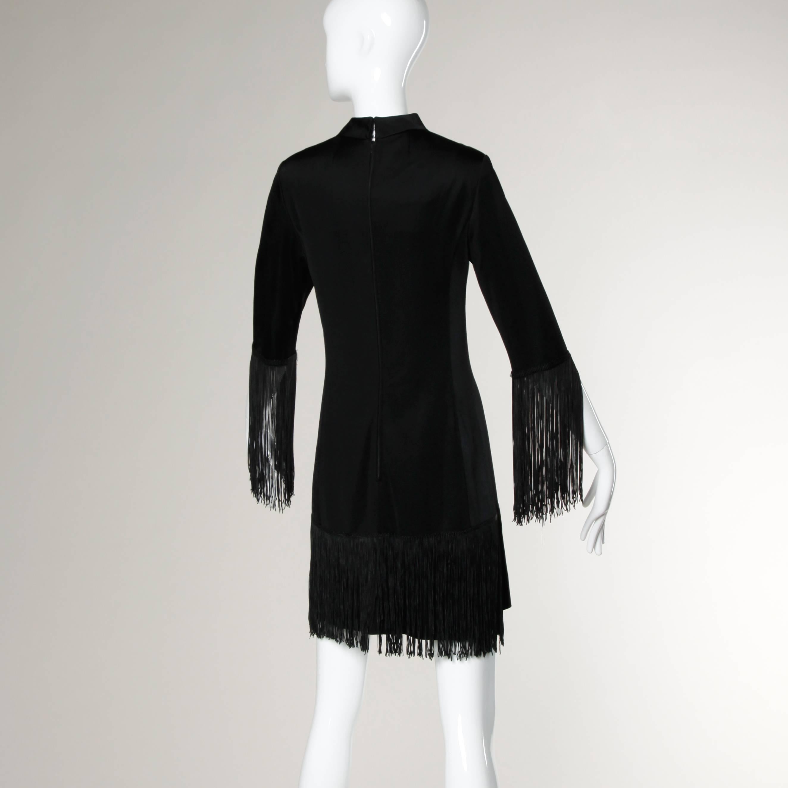 So wearable! Vintage black button up cocktail dress with fringe on the cuffs and hem. By Victor Costa for Lord & Taylor.

Details:

Fully Lined
Front Button Closure/ Back Zip and Hook Closure 
Marked Size: Not Marked
Estimated Size: