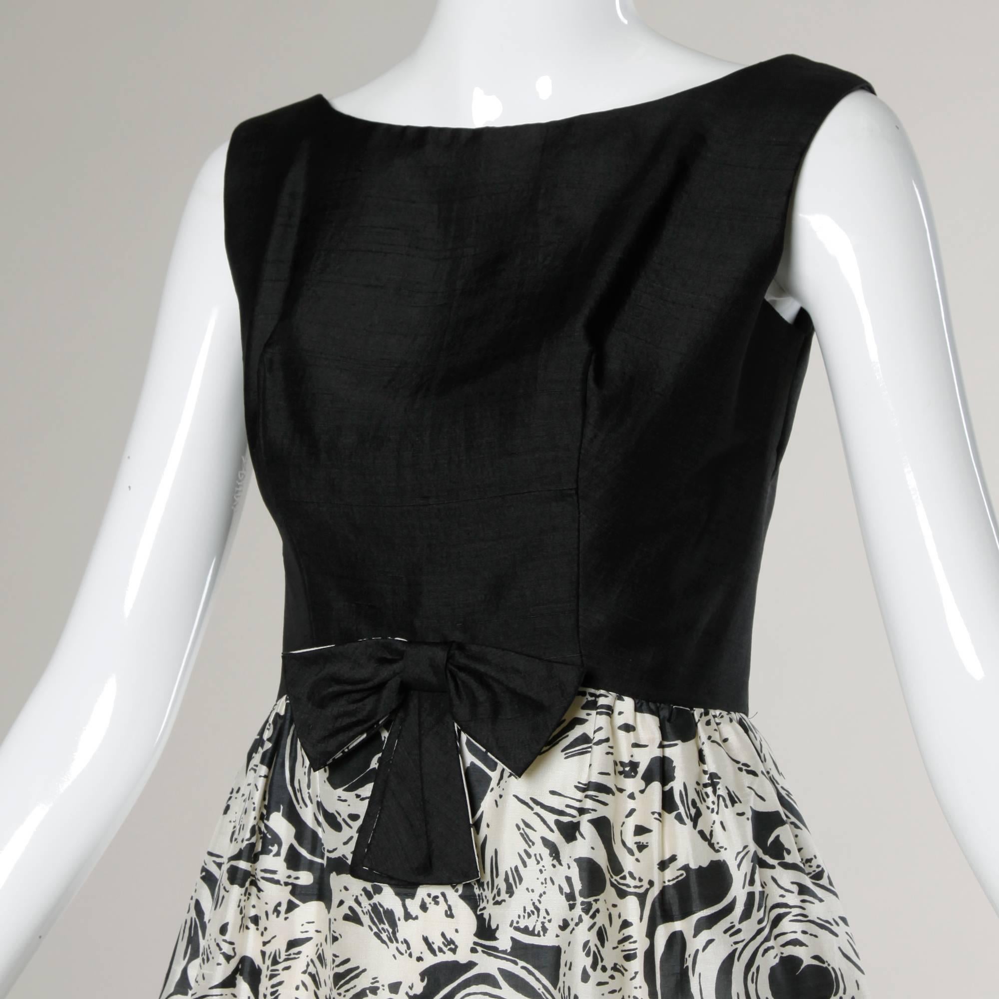 Pretty vintage cocktail dress from the 1960s. Graphic print black and white silk fabric and front bow embellishment.

Details:

Fully Lined
Back Metal Zip and Hook Closure 
Marked Size: Not Marked
Estimated Size: Small
Color: Black/