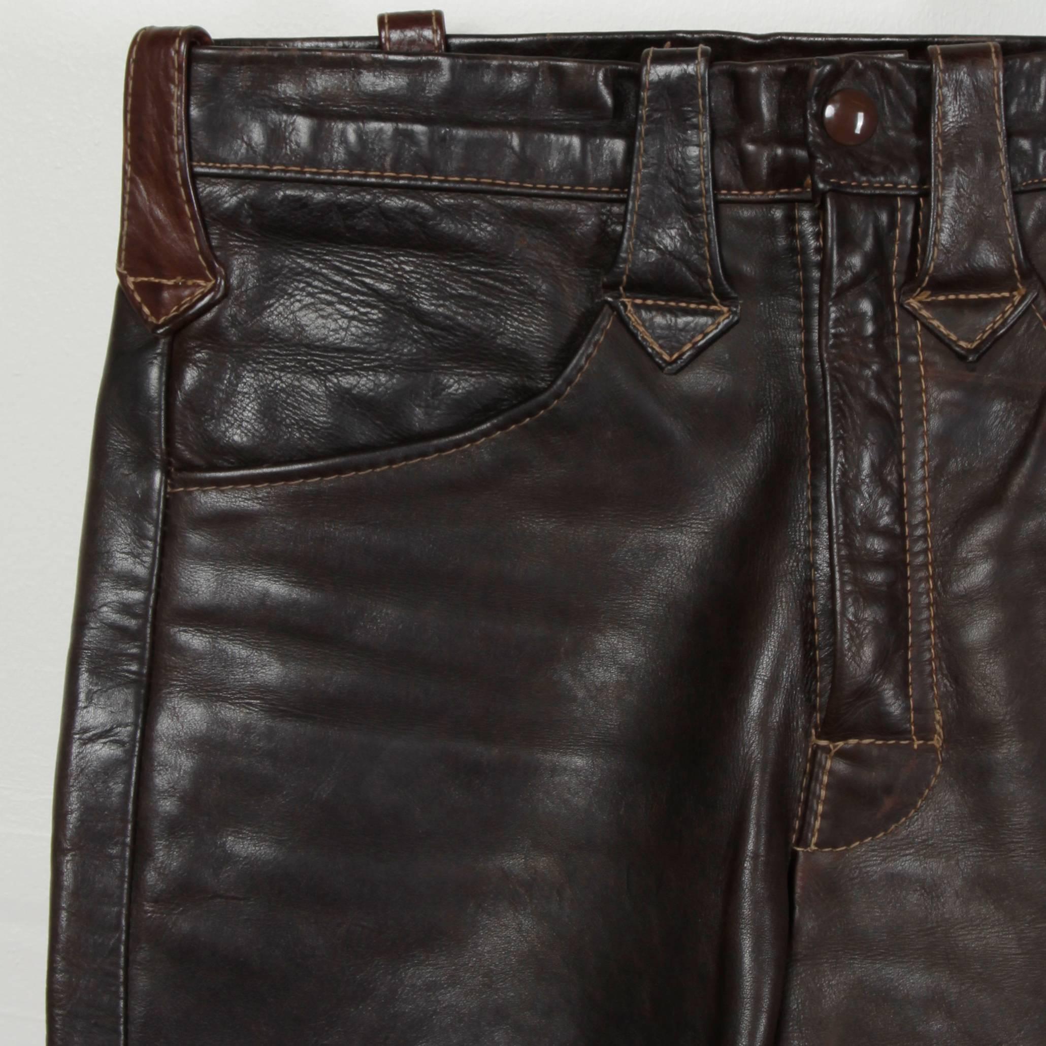 Legendary East West Musical Instruments vintage hand crafted leather bell bottom pants in dark brown. Flared leg and supple worn in leather with an excellent patina and plenty of wear left in them. Highly collectible label with the phone number of