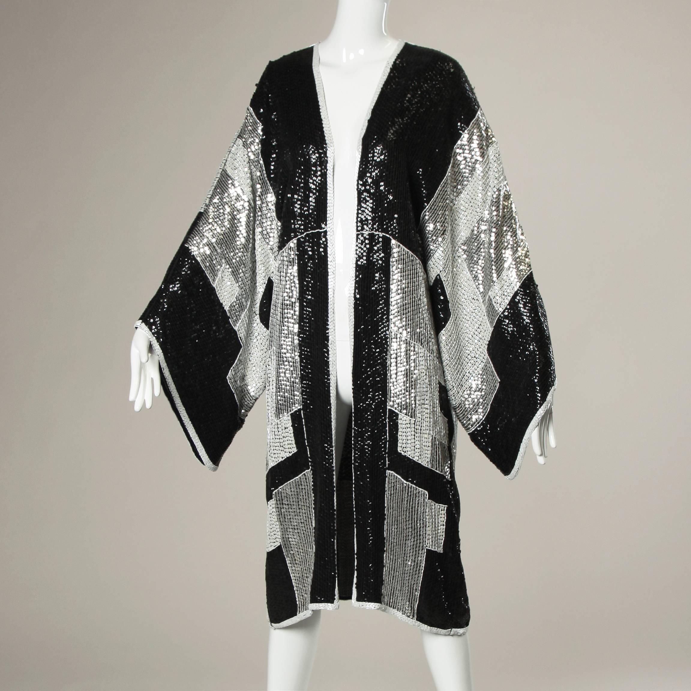 Unbelievable vintage 1985 Jeanette Kastenberg kimono jacket or duster with massive dolman sleeves and long oversized fit. Entirely covered in tiny sequins and beads. Incredible piece!

Details:

Unlined
Back Zip and Hook Closure
Marked Size: