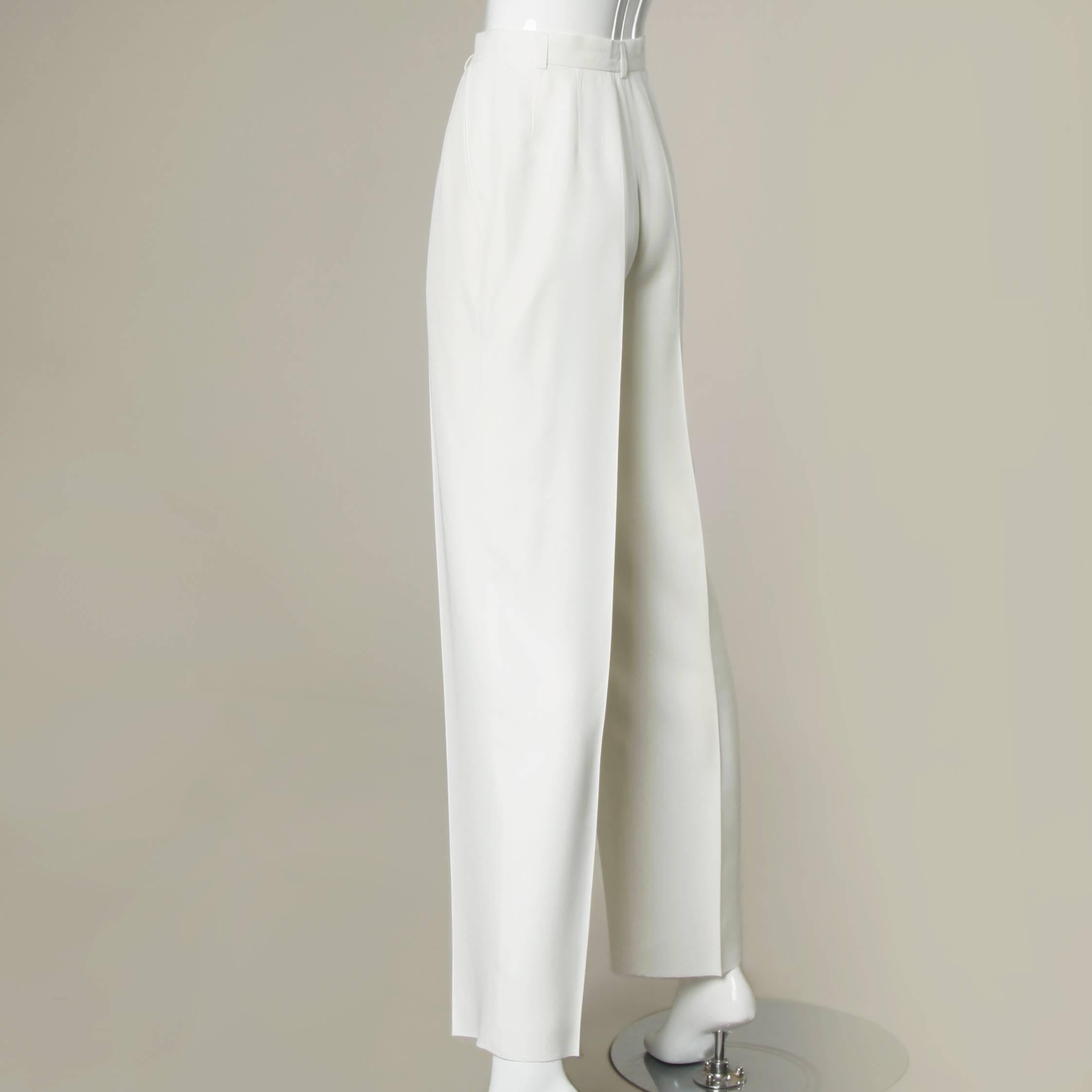 Sleek white high waisted trousers by Louis Feraud. Belt loops and pleated front.

Details:

Fully Lined
Side Pockets
Front Button and Zip Closure
Marked Size: US 4/ UK 8/ F 36/ D 34
Estimated Size: Small
Color: White
Fabric: 95% Rayon/ 5%