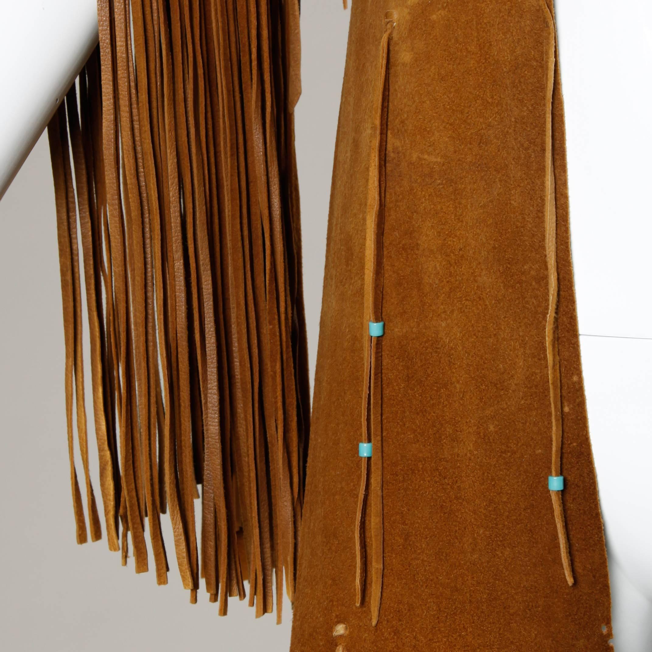 Rare vintage Native American hand-crafted buckskin coat with fringe leather trim. 

Details:

Unlined
Estimated Size: Small
Color: Tan
Fabric: Buckskin
Hand Crafted

Measurements:

Bust: 32