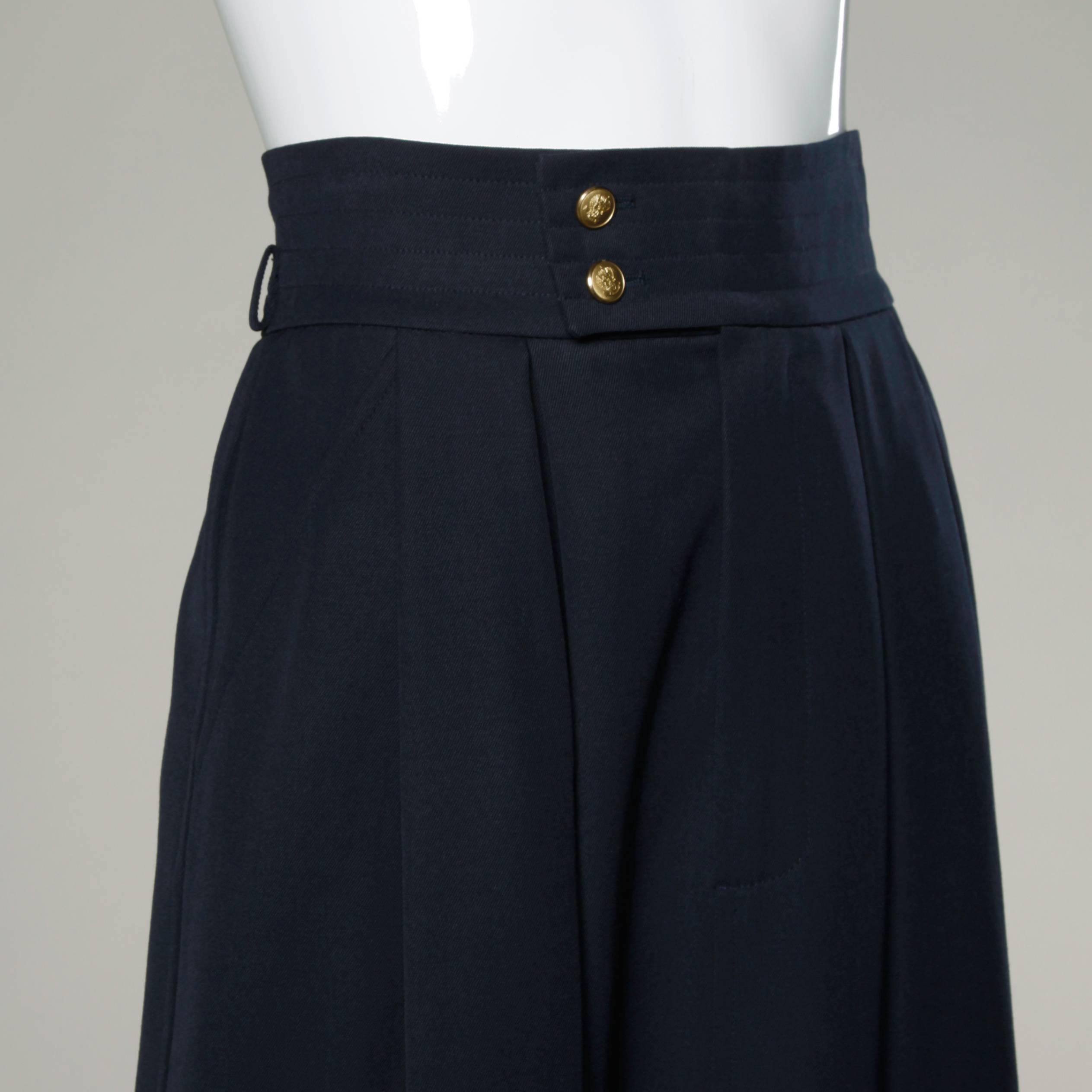 Vintage navy wool midi skirt with two front box pleats by Saint-Laurent.

Details:

Fully Lined
Front Pockets
Front Button and Hook Closure
Marked Size: F 36
Estimated Size: Small
Color: Navy Blue
Fabric: Wool
Label: Saint Laurent
